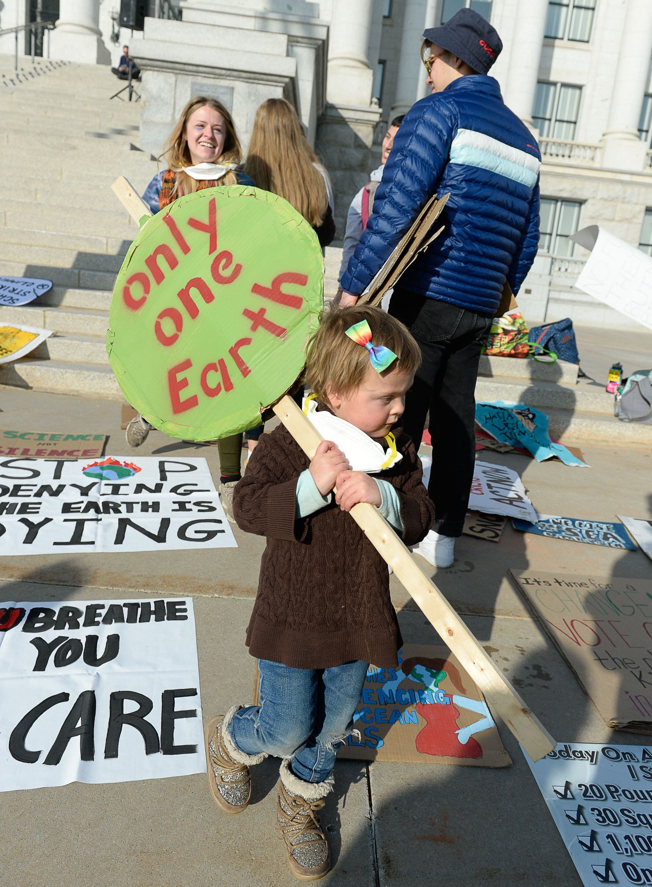 (Francisco Kjolseth | The Salt Lake Tribune) Lilly Moore, 3, joins other environmental activists at the Utah Capitol for a rally on climate action on Friday, Dec. 6, 2019.