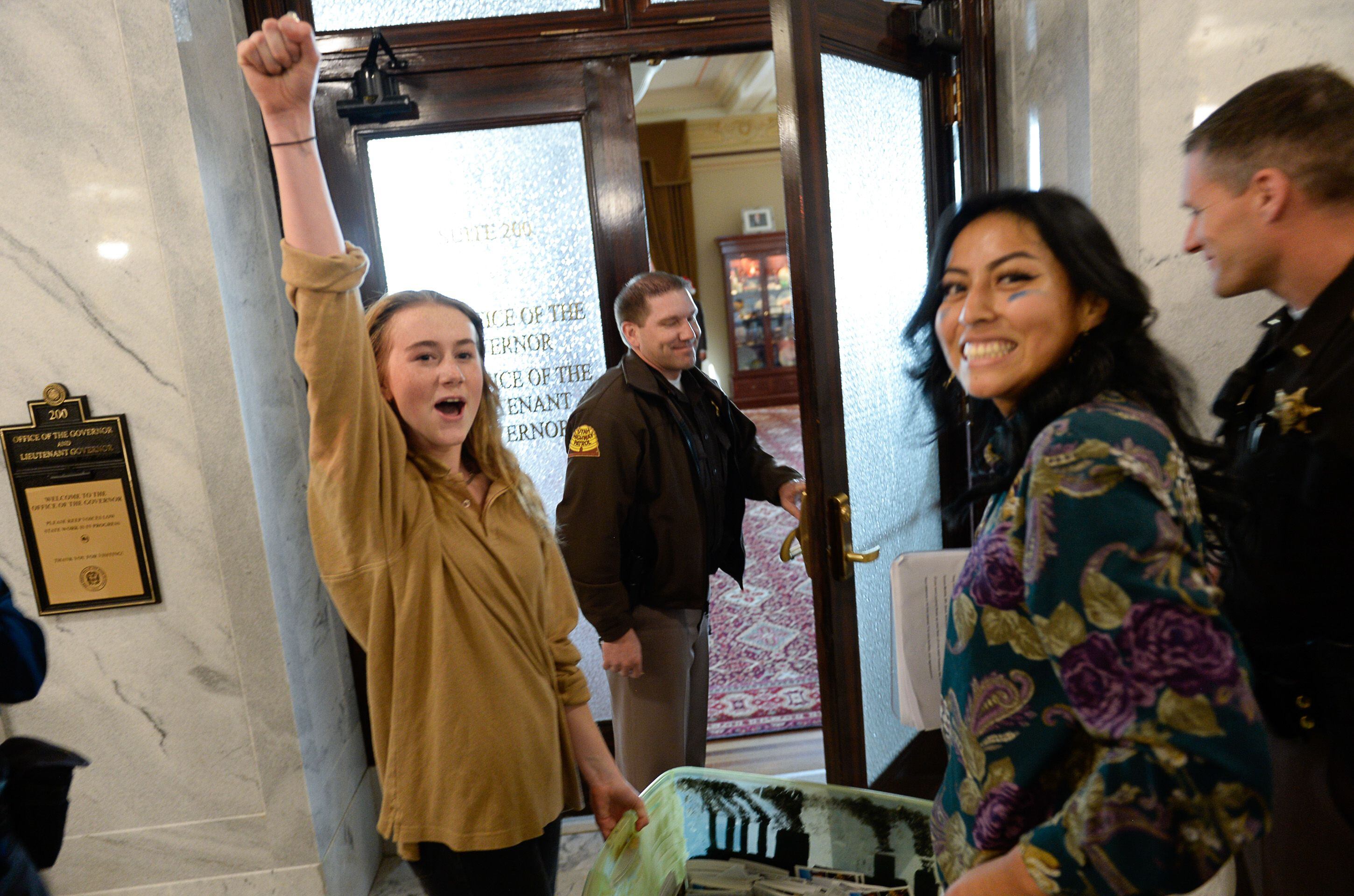 (Francisco Kjolseth | The Salt Lake Tribune) Nina Serafin, left, and Raquel Juarez are joined by numerous other students outside the office of Gov. Gary Herbert on the Utah Capitol on Friday, Dec. 6, 2019, as they deliver over 4,000 written cards with the importance of protecting Utah lands and clean air solutions. Because of security reasons they were told they would have to mail the cards instead. Fridays For Future, Utah Youth Environmental Solutions, and partners strike in opposition to UtahÕs final oil and gas lease sale of 2019 that will auction off public lands and further fossil fuel development.