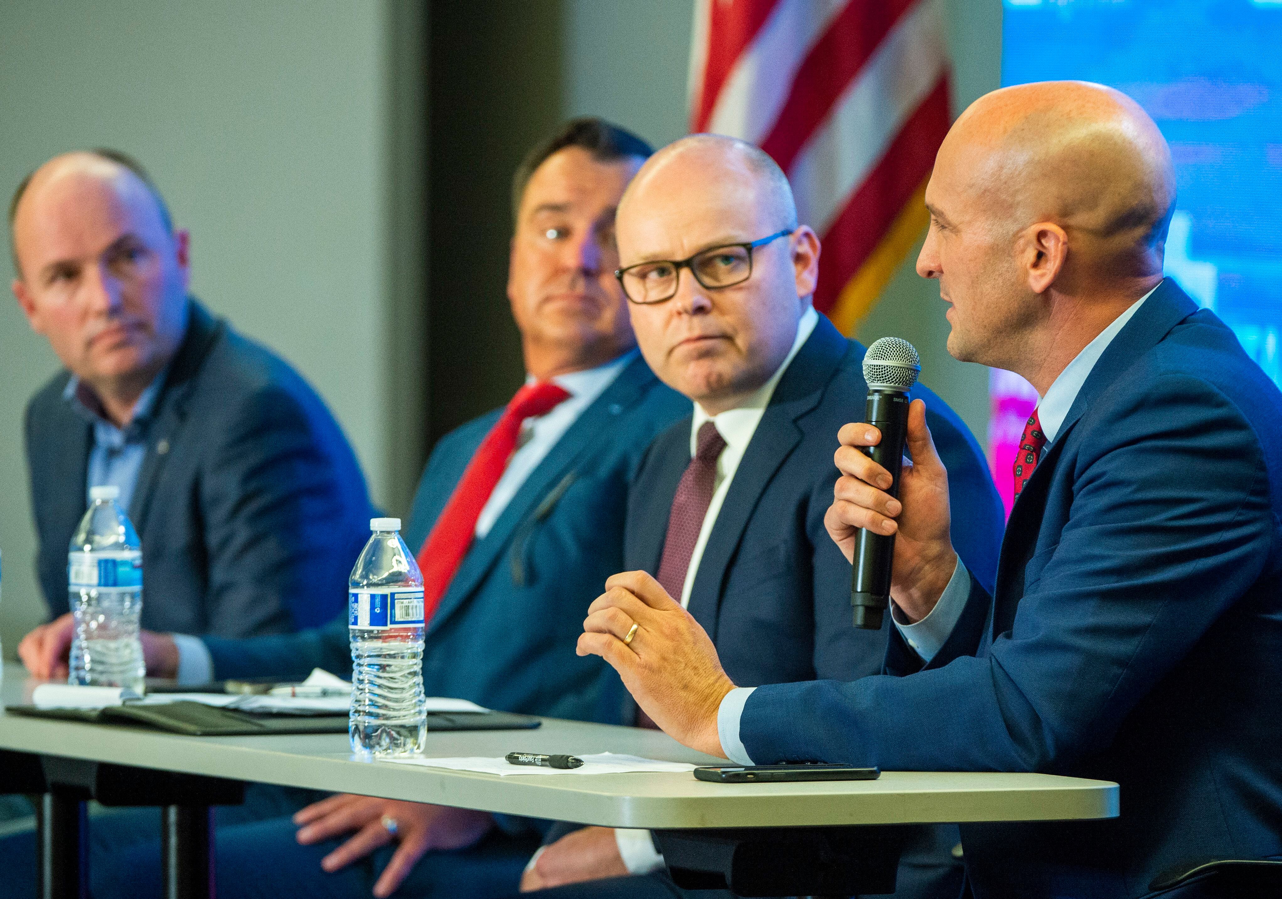 (Rick Egan | The Salt Lake Tribune) Spencer Cox, Greg Hughes, and Jeff Burningham look on, as Thomas Write answers a question during a Panel of Gubernatorial Candidates, at the annual Utah Eagle Forum Convention, in Sandy, Saturday, Jan. 11, 2020.