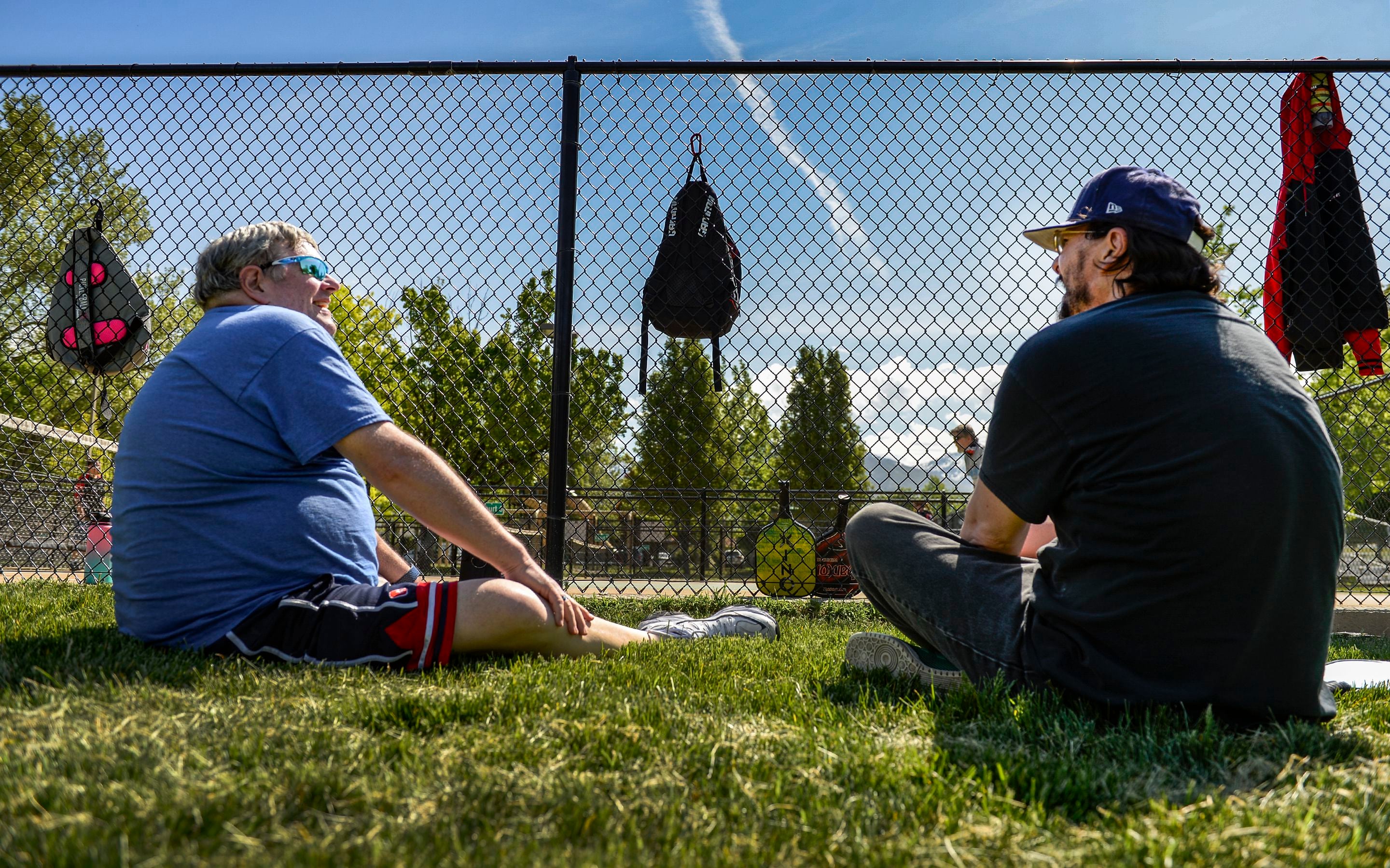 (Leah Hogsten | The Salt Lake Tribune) l-r Veterans Blaine Anderson and Peter Gray share a laugh while taking a break from pickleball play at Hogan Park in Bountiful, May 14, 2019. Veteran suicide rates in Utah, are second highest, with the exception of Montana. The non-profit group Continue Mission serves the Veteran population to heal physical, mental, and emotional injuries through recreational programs like pickleball to promote health, mental well-being and positive life changing experiences.