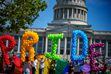 (Trent Nelson  |  The Salt Lake Tribune) People march from the Utah Capitol in Salt Lake City to kick off the Utah Pride Festival on Saturday, June 1, 2024.