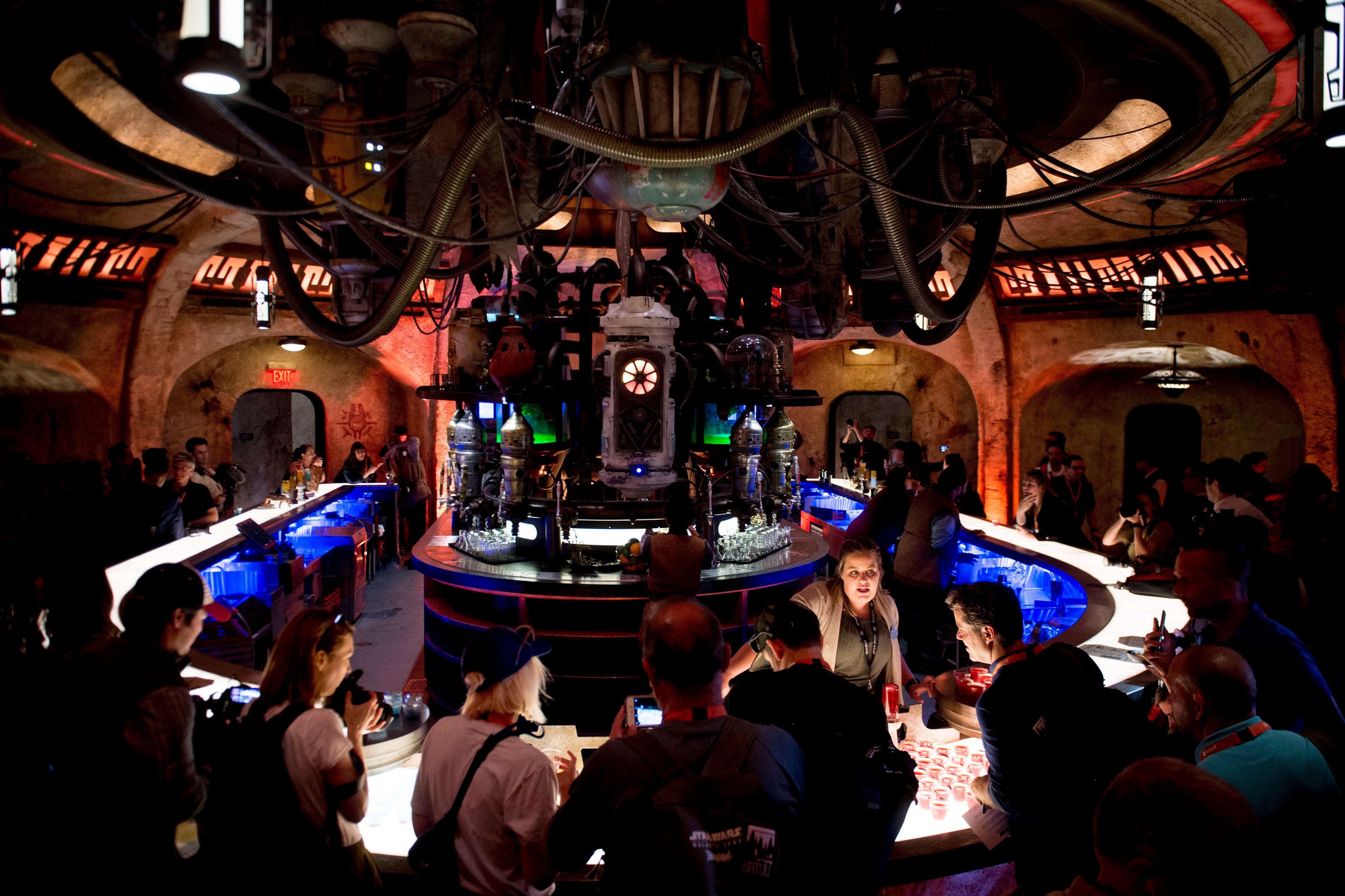 (Jeremy Harmon | The Salt Lake Tribune) Patrons sample drinks at Oga's Cantina at Star Wars: Galaxy's Edge in Anaheim, Ca. on Wednesday, May 29, 2019. The cantina is reminiscent of the one in the original Star Wars film from 1977.