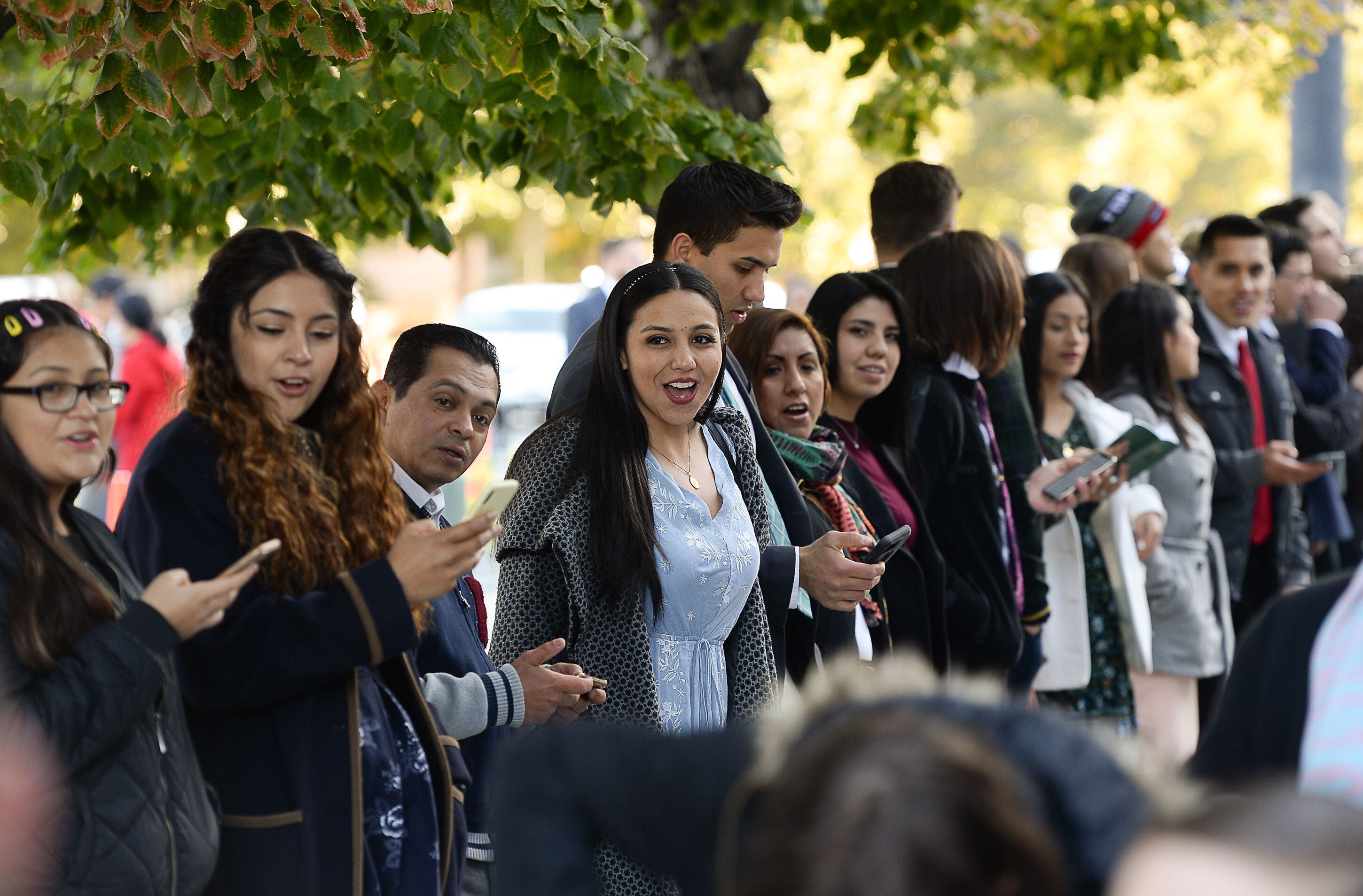 (Francisco Kjolseth | The Salt Lake Tribune) The faithful sing hymnals in Spanish as people arrive for the Sunday session of the 189th twice-annual General Conference of The Church of Jesus Christ of Latter-day Saints at the Conference Center in Salt Lake City on Sunday, Oct. 6, 2019.