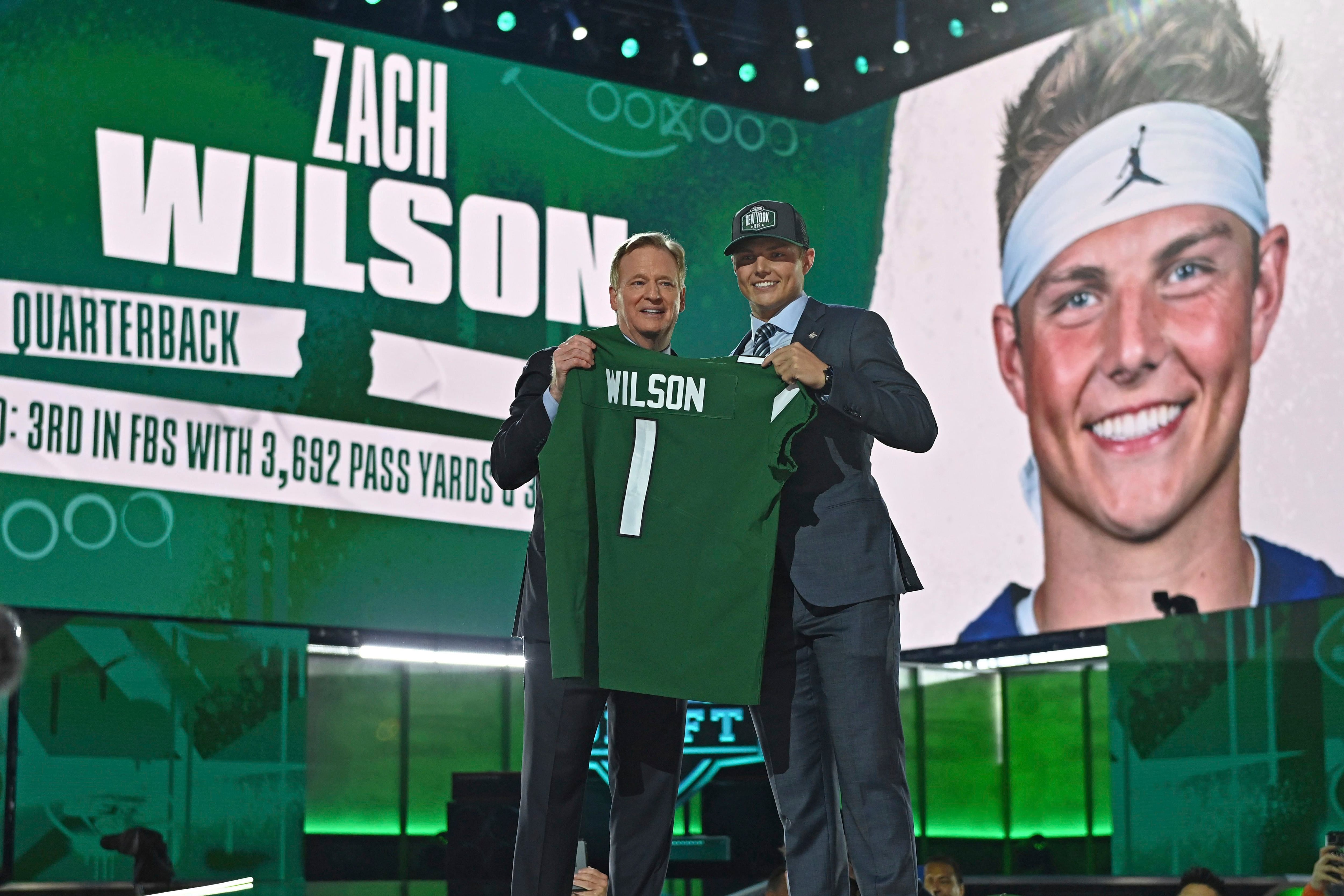 BYU quarterback Zach Wilson holds a New York Jets jersey on stage after  being selected second overall in the first round of the NFL football draft,  Thursday, April 29, 2021, in Cleveland. (