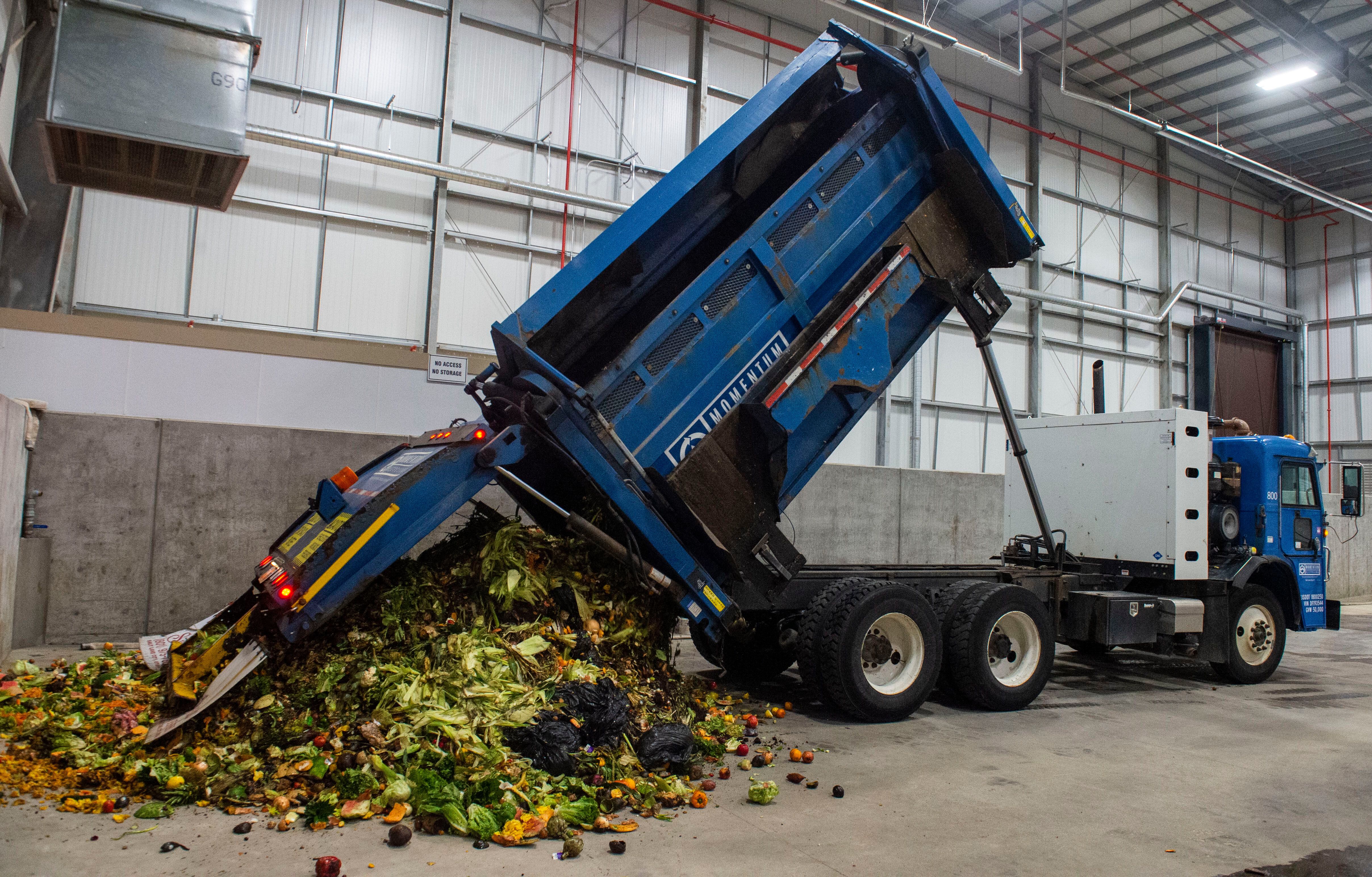 (Rick Egan | The Salt Lake Tribune) A truck from Momentum recycling dumps a load of food waste at Wasatch Resource Recovery in North Salt Lake. Friday, May 24, 2019.