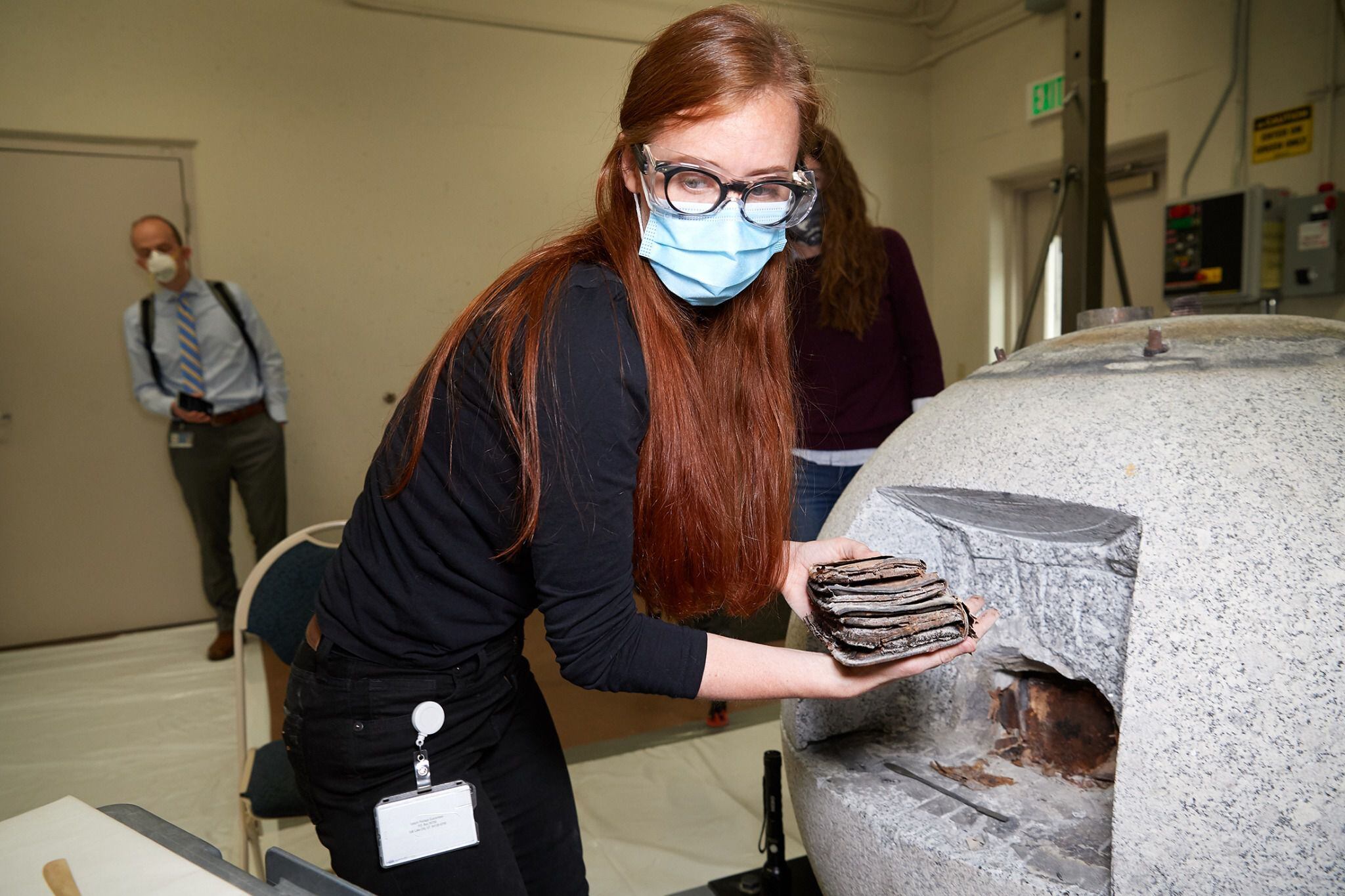 (photo courtesy The Church of Jesus Christ of Latter-day Saints) Emiline Twitchell, a conservator at the Church History Library, removes items from the capstone of the Salt Lake Temple on May 20, 2020.
