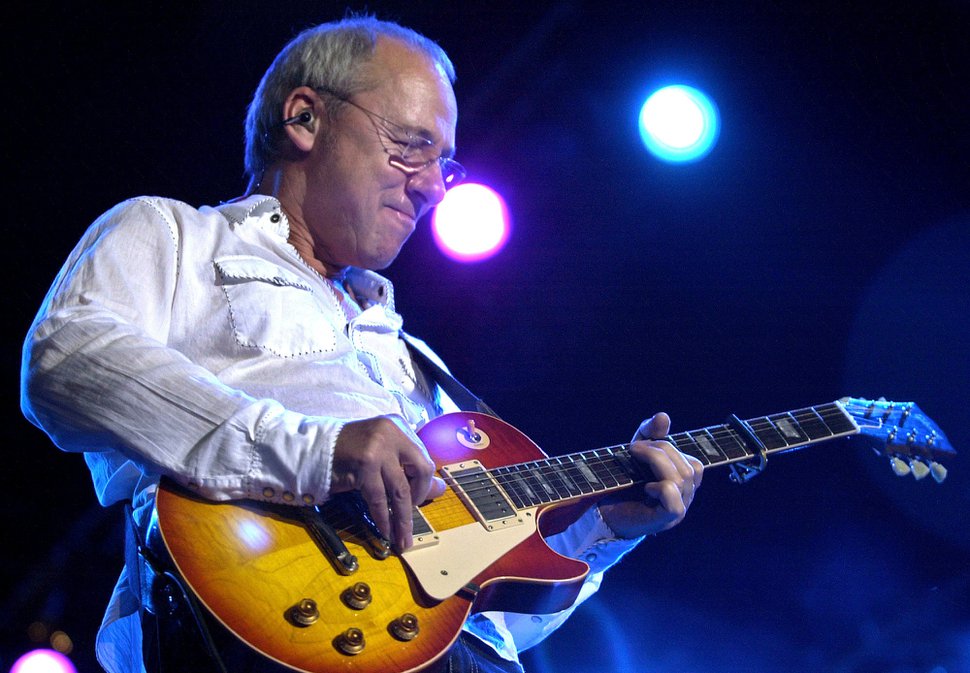 Mark Knopfler kept his guitar fingers warm at a soppy, cold Red Butte