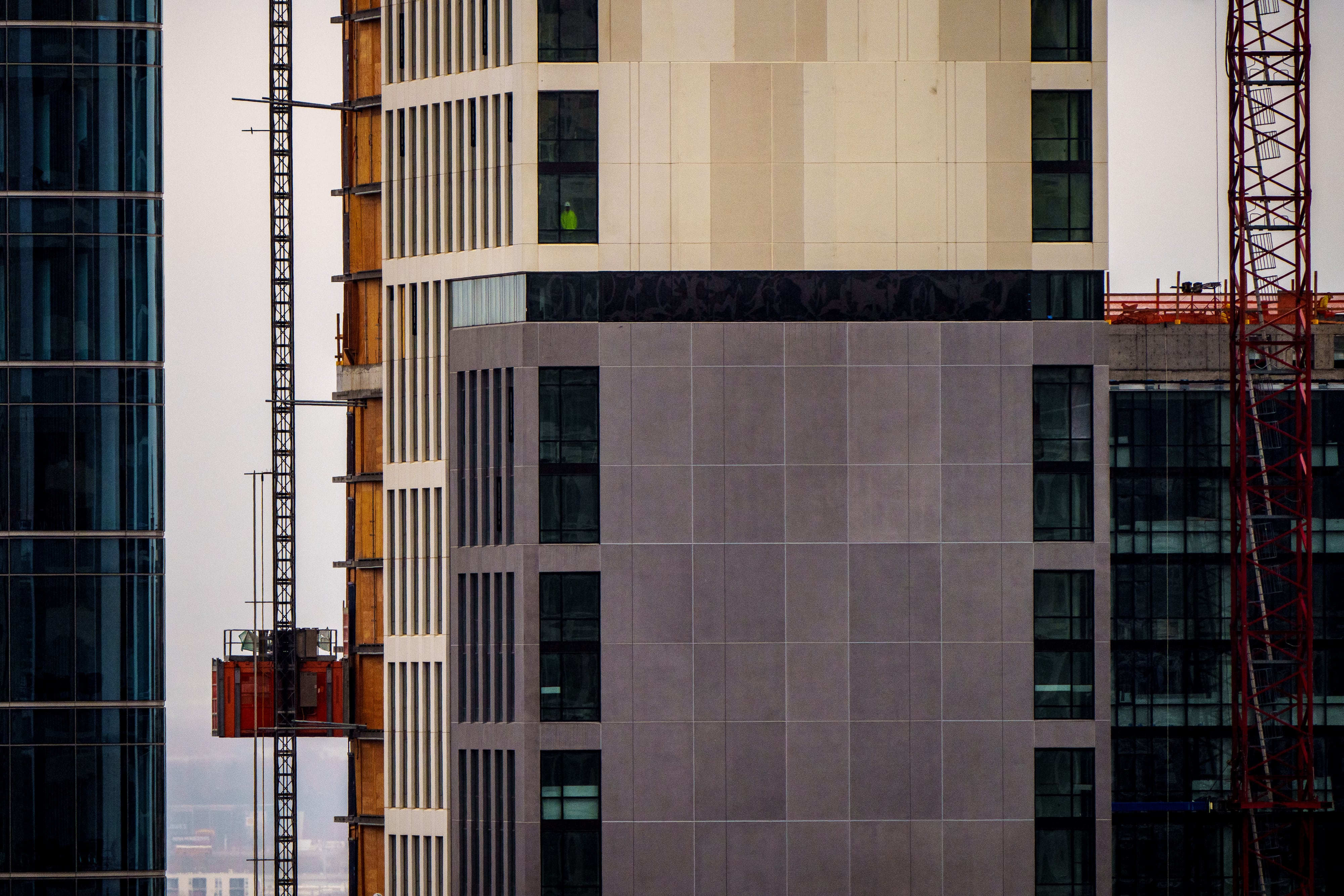 (Trent Nelson | The Salt Lake Tribune) A construction worker looks out on the city from Astra Tower in Salt Lake City on Tuesday, March 12, 2024.