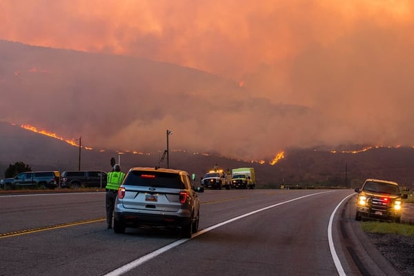 (Courtesy of Duchesne County Sheriff's Office) Emergency responders watch as the Dollar Ridge Fire nears Highway 40 near Fruitland on Wednesday, July 4, 2018. The fire later crossed the road, forcing crews to close the highway.