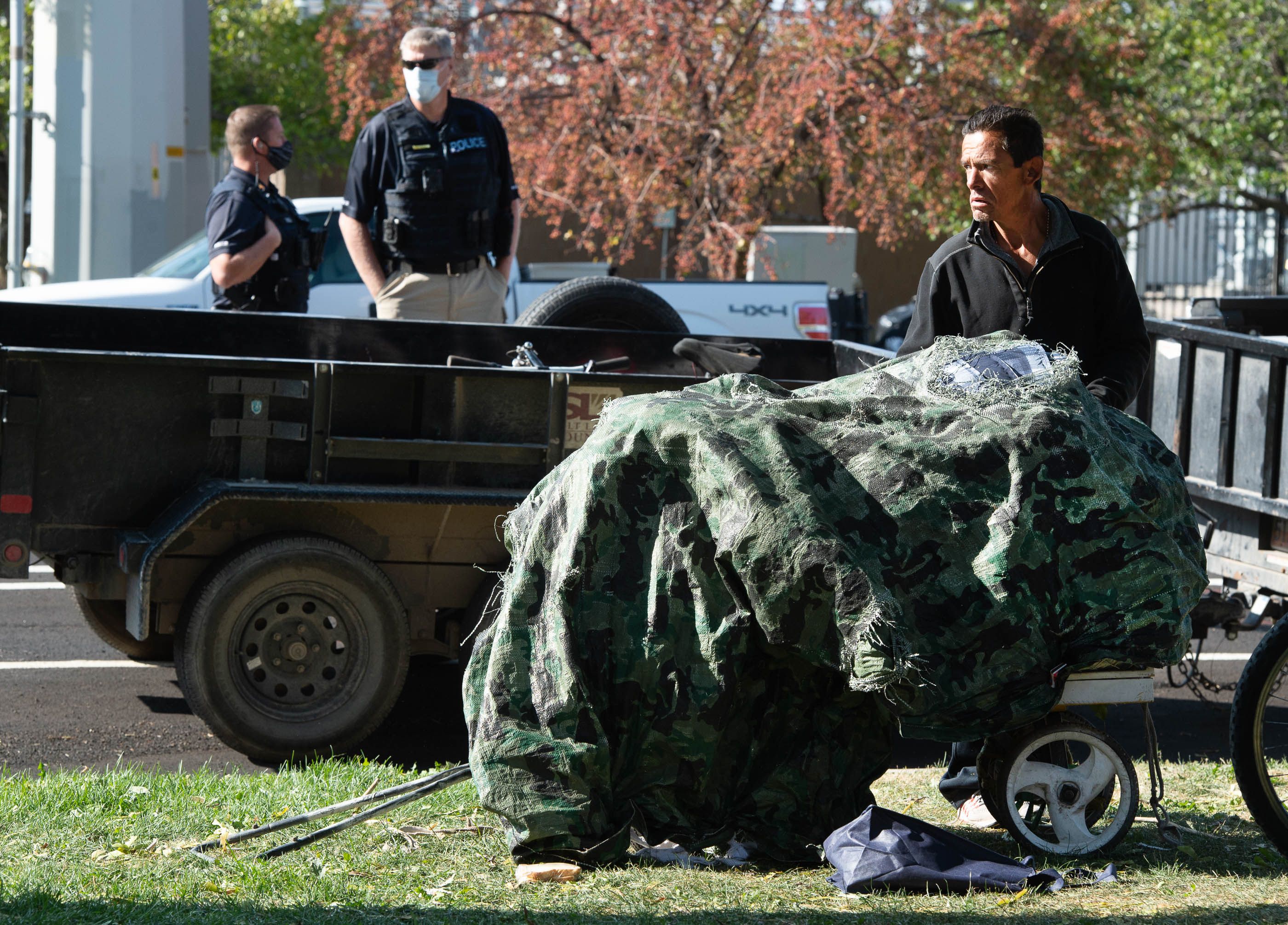 (Francisco Kjolseth | The Salt Lake Tribune) Daniel Castiano is forced to pack up his belonging as the Salt Lake County Health Department cleans up the homeless camp set up near Taufer Park in Salt Lake City on Thursday, Sept. 10, 2020. Notified the day before, the health department, backed by police, cleaned up the camps as homeless advocates confronted the police abhorring their actions.