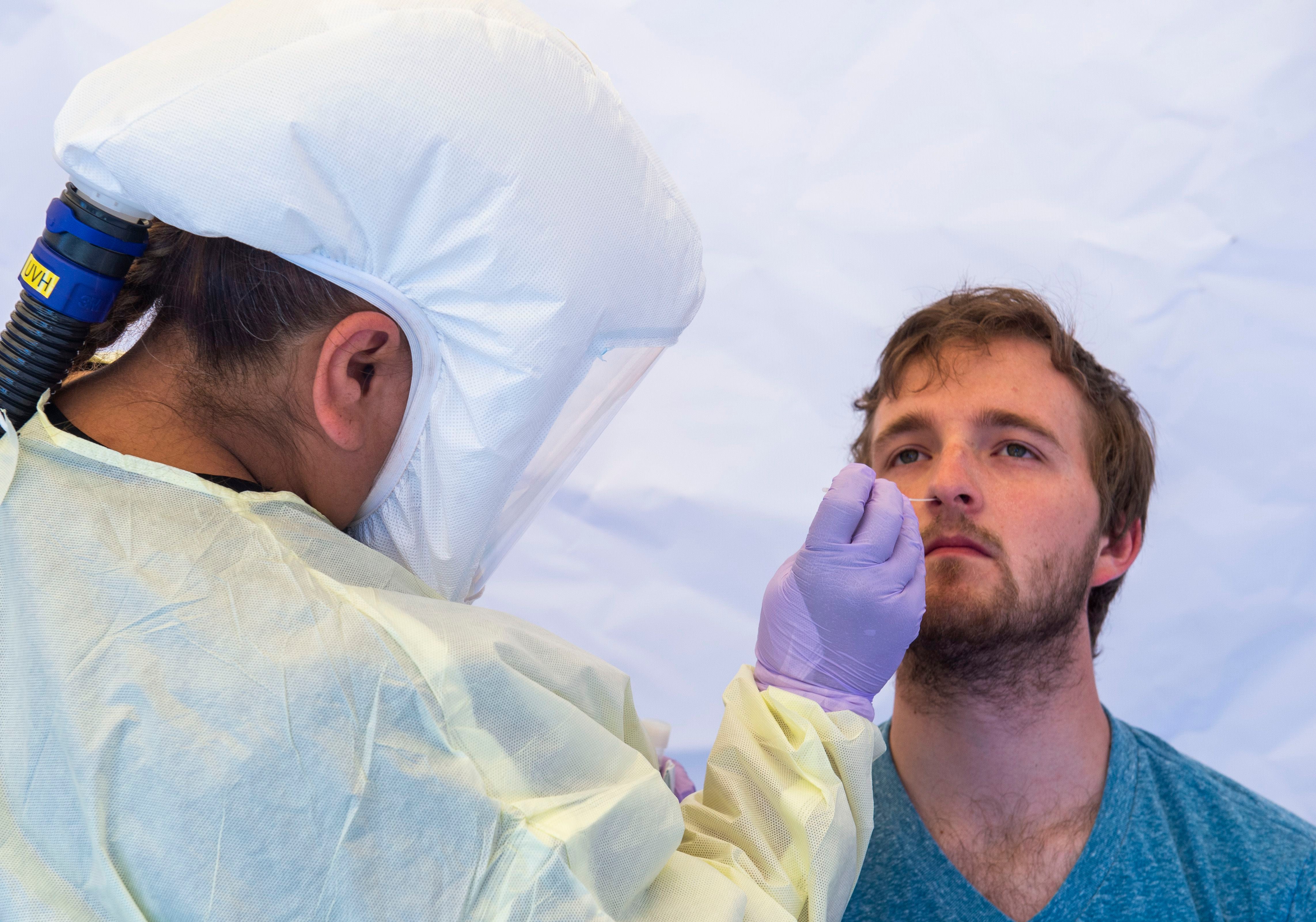 (Rick Egan | The Salt Lake Tribune) Intermountain Healthcare medical assistant, Latoya Dovila, tests Preston Jenson, at the Intermountain Healthcare Coronavirus Mobile Testing Unit at Utah Valley Hospital in Provo, Friday May 8, 2020