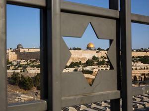 (Oded Balilty | AP)The Islamic Dome of the Rock in Jerusalem's Old City is seen trough a door decorated with a Jewish Star of David in 2017. Columnist Jeffrey Salkin explains how Jewish adherents believe life goes on after death.