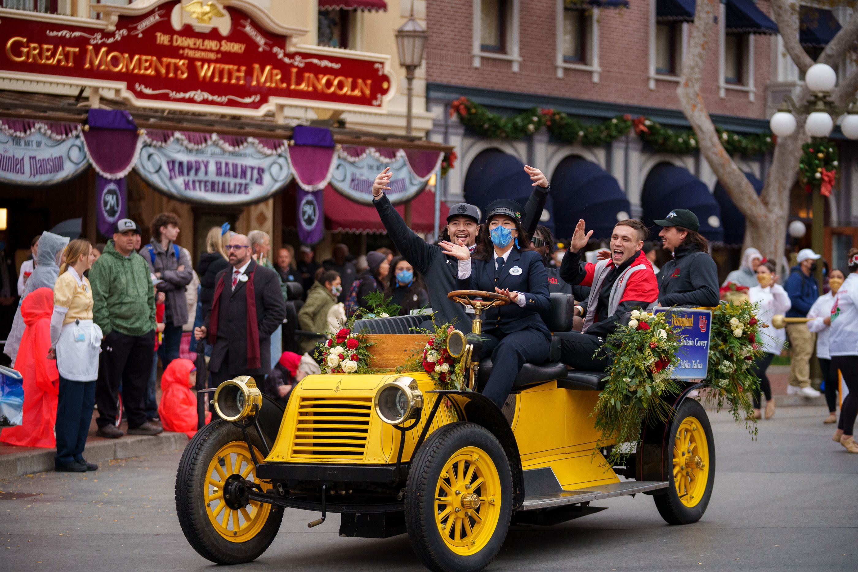 (Trent Nelson | The Salt Lake Tribune) Mika Tafua, Devin Lloyd, Britain Covey and Cameron Rising ride down Disneyland's Main Street during the Rose Bowl Game Cavalcade in Anaheim, Calif., on Monday, Dec. 27, 2021.