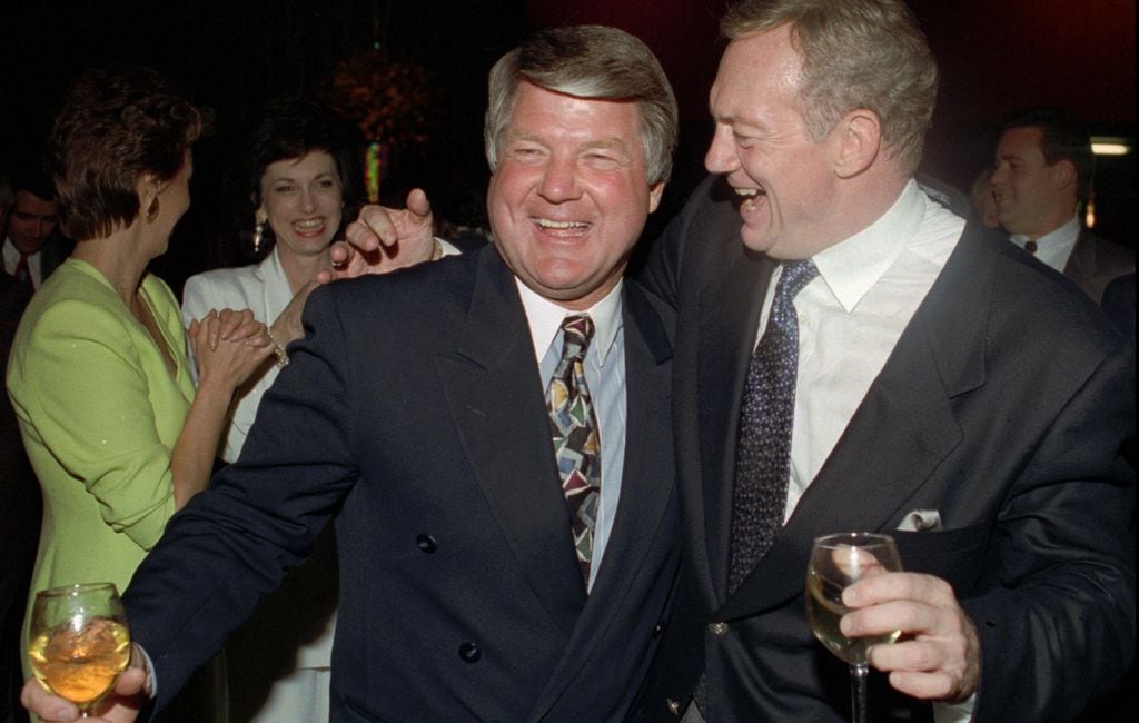 Former Dallas Cowboys head coach Jimmy Johnson, left, hands