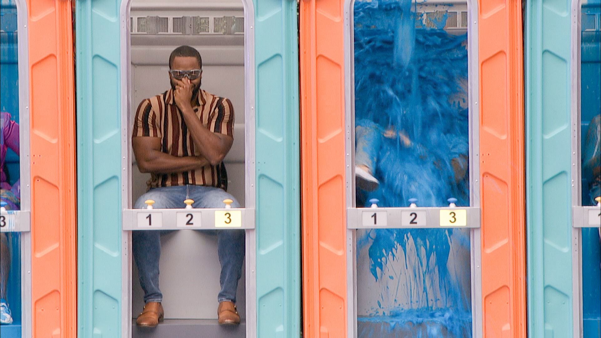 (CBS) Kyle Capener, right, is turned blue as he loses his first challenge on "Big Brother."