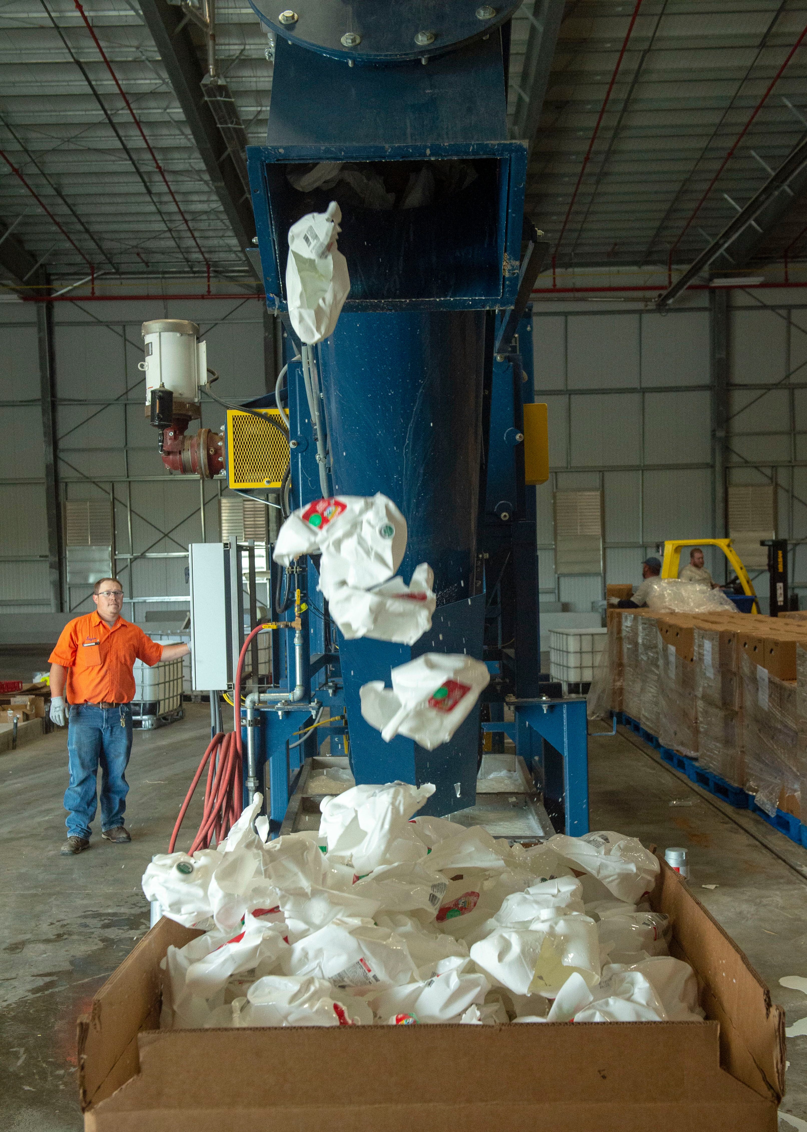 (Rick Egan | The Salt Lake Tribune) Empty milk containers come out of the de-bottling machine at Wasatch Resource Recovery in North Salt Lake. Friday, May 24, 2019.