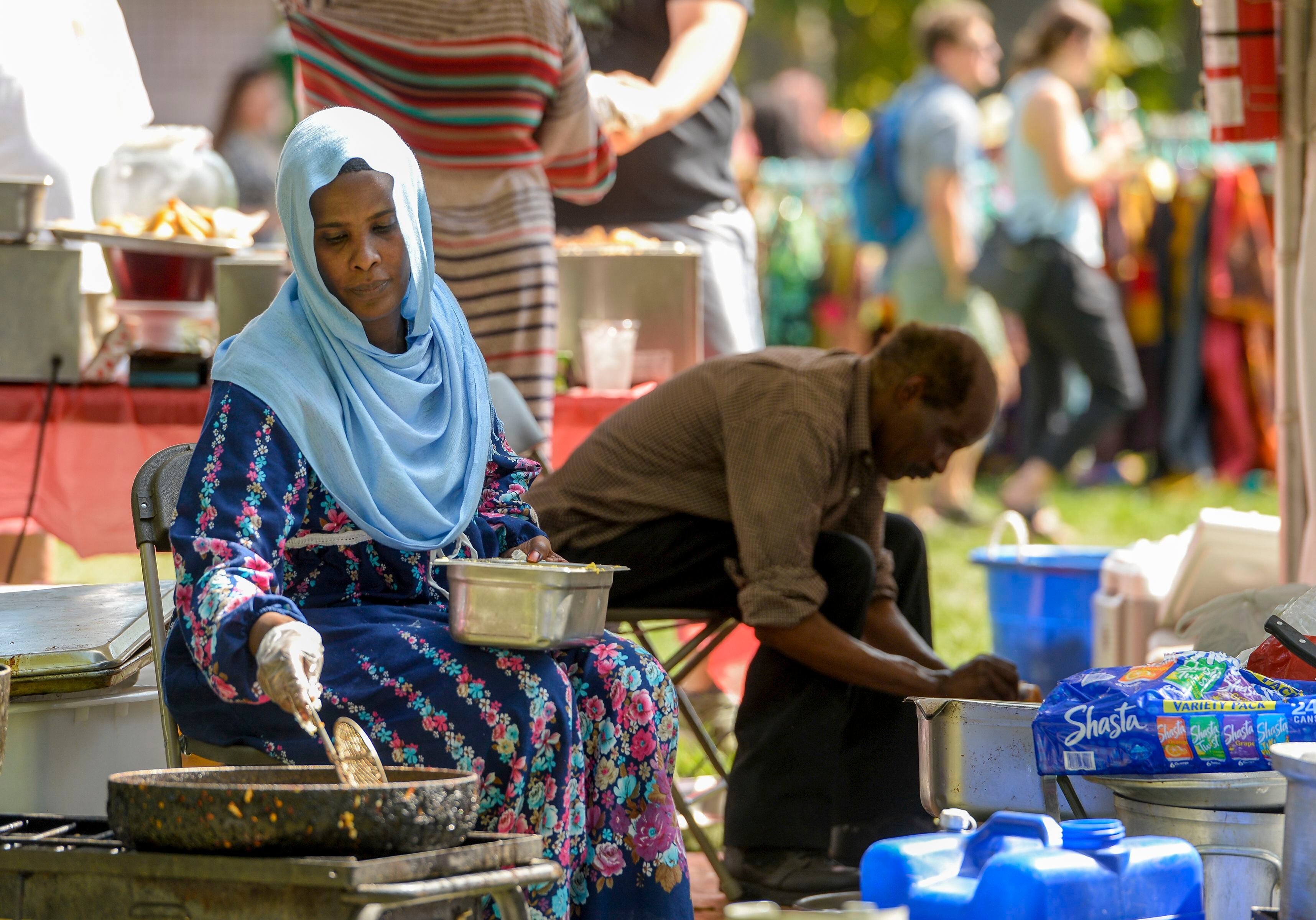 (Leah Hogsten | The Salt Lake Tribune) Rabab Omer frys falafel and other Sundanese foods during the 4th Annual African Festival sponsored by the United Africans of Utah, Saturday, July 27, 2019 at Liberty Park. The African Festival promotes African tradition, culture and heritage through the arts, food fashion, music and dance.