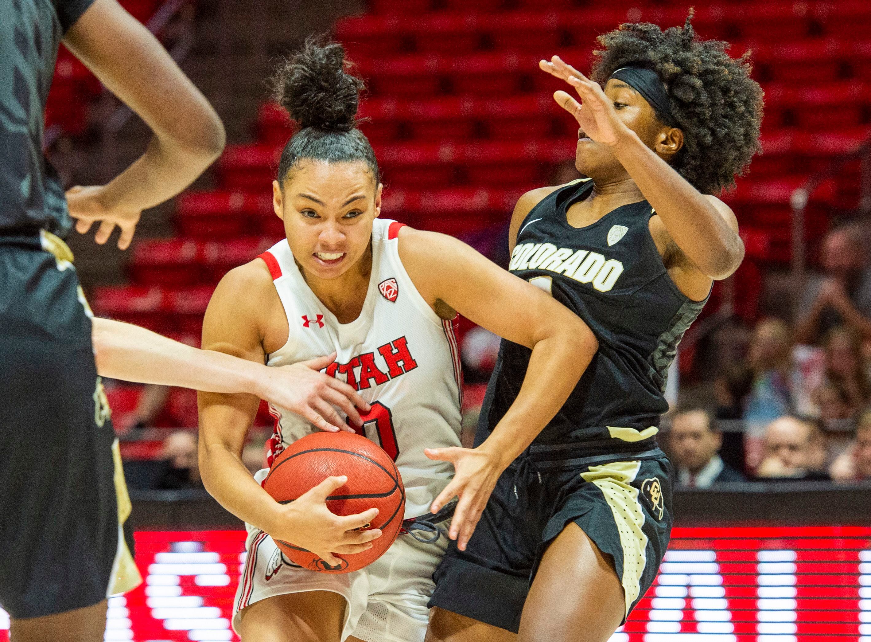 (Rick Egan | The Salt Lake Tribune) Utah Utes guard Kiana Moore (0) takes the ball down court, as Colorado Buffaloes guard Jaylyn Sherrod (1) defends, in PAC-12 basketball action between the Utah Utes and the Colorado Buffaloes, at the Jon M. Huntsman Center, Sunday, Nov. 29, 2019.