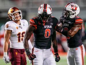 Utah linebacker Devin Lloyd holds a team jersey after he was