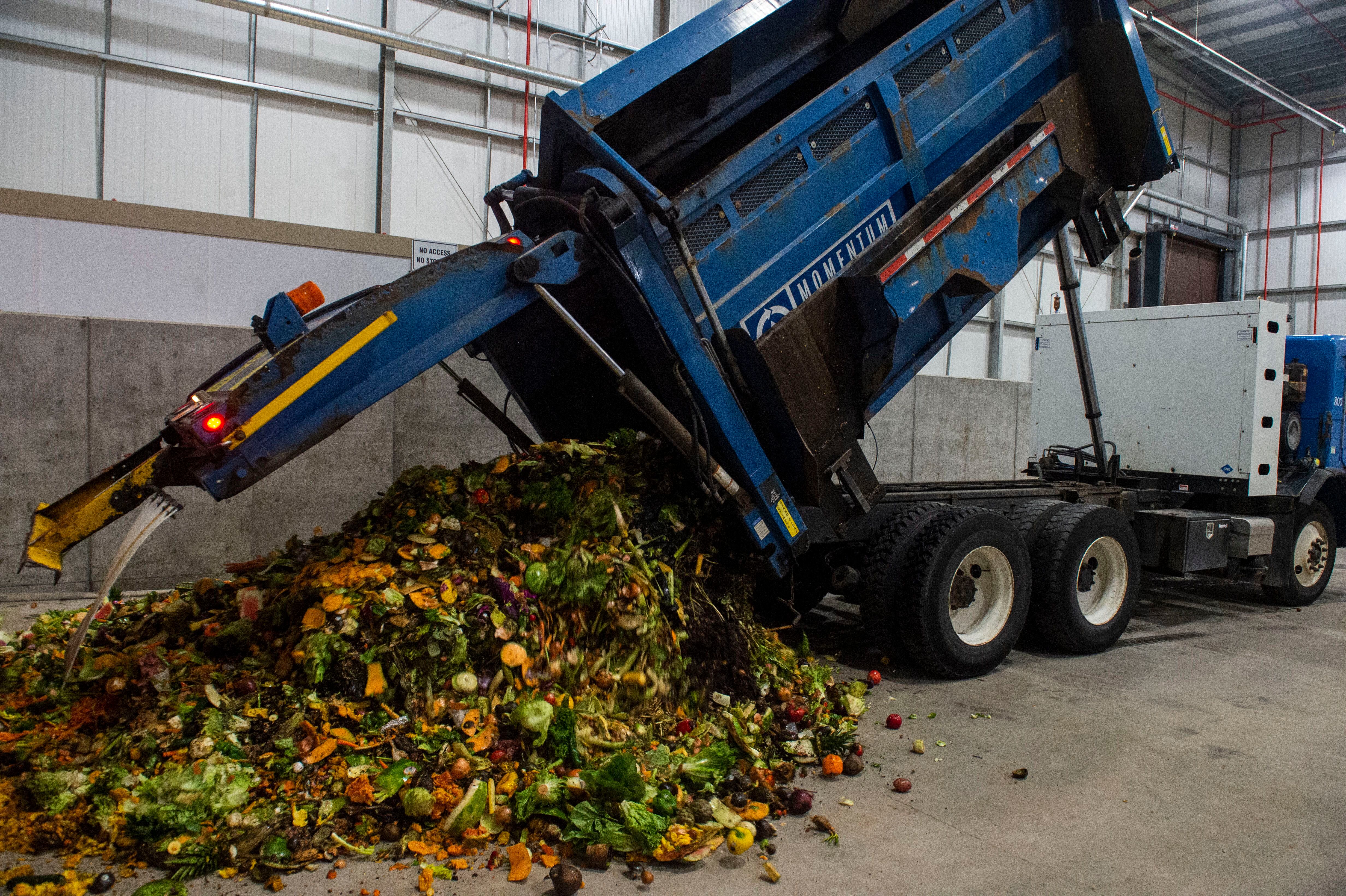 (Rick Egan | The Salt Lake Tribune) A truck from Momentum recycling dumps a load of food waste at Wasatch Resource Recovery in North Salt Lake. Friday, May 24, 2019.