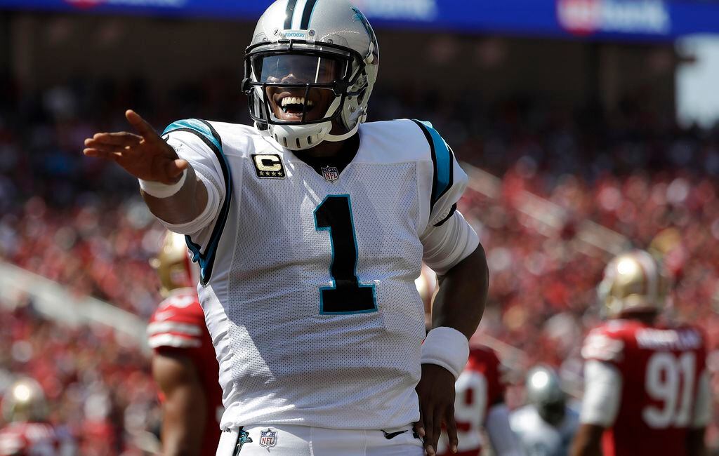 Panthers quarterback Cam Newton throws a pass down filed