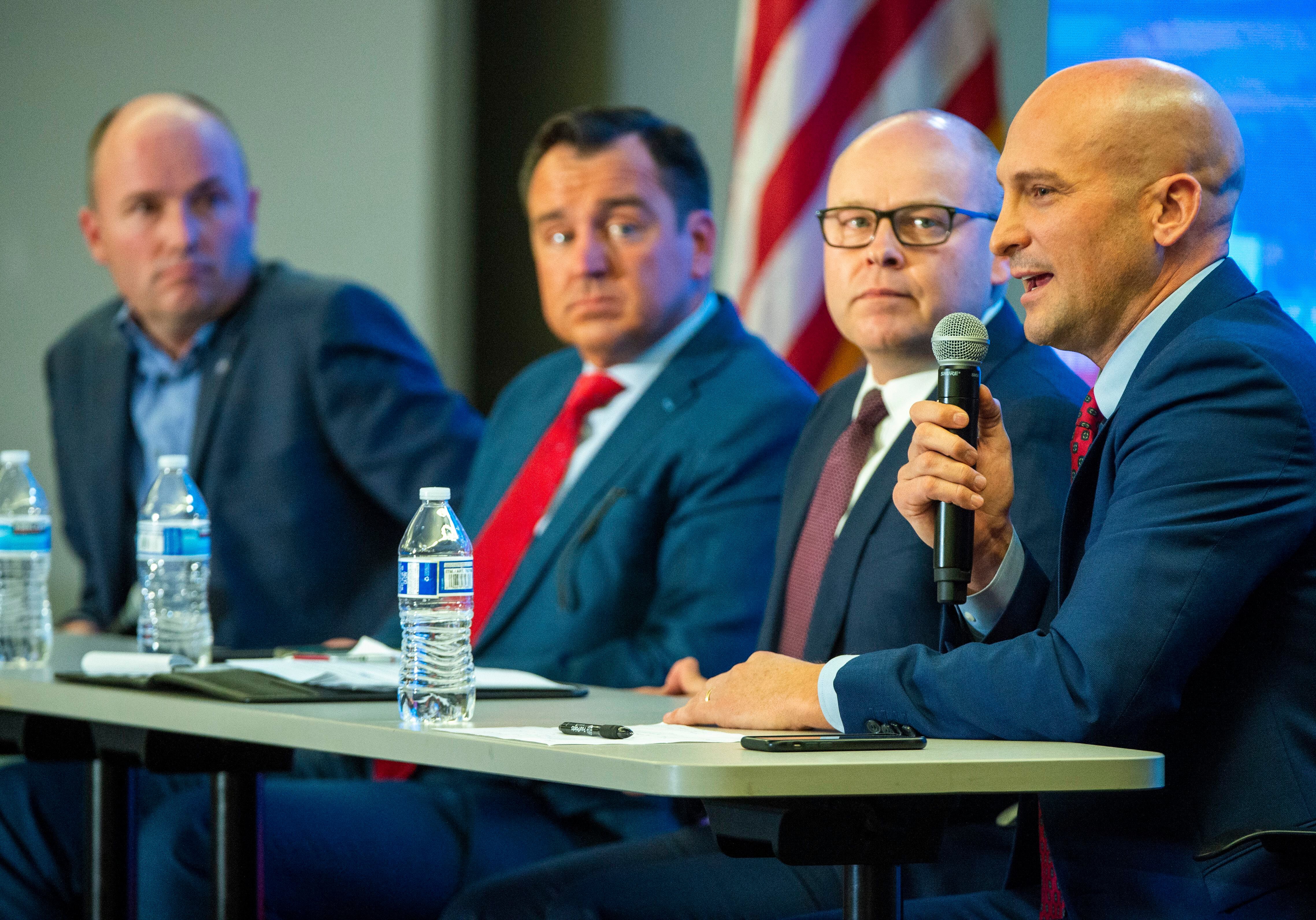 (Rick Egan | The Salt Lake Tribune) Spencer Cox, Greg Hughes, and Jeff Burningham look on, as Thomas Write answers a question during a Panel of Gubernatorial Candidates, at the annual Utah Eagle Forum Convention, in Sandy, Saturday, Jan. 11, 2020.