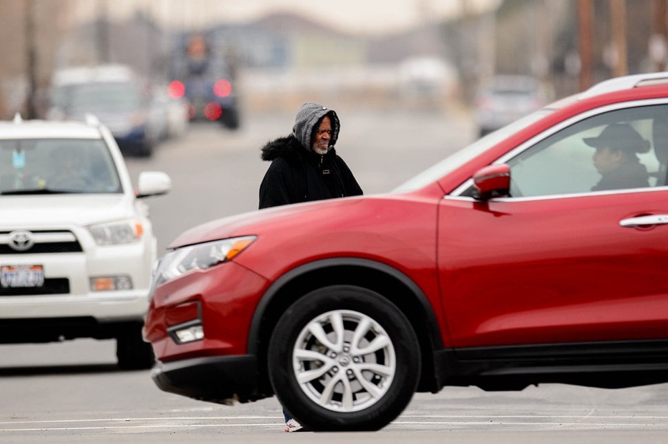 (Trent Nelson | The Salt Lake Tribune) A man stands in the road as traffic passes on 3300 South near the Road Home's South Salt Lake Men's Resource Center in South Salt Lake on Tuesday, Dec. 31, 2019.