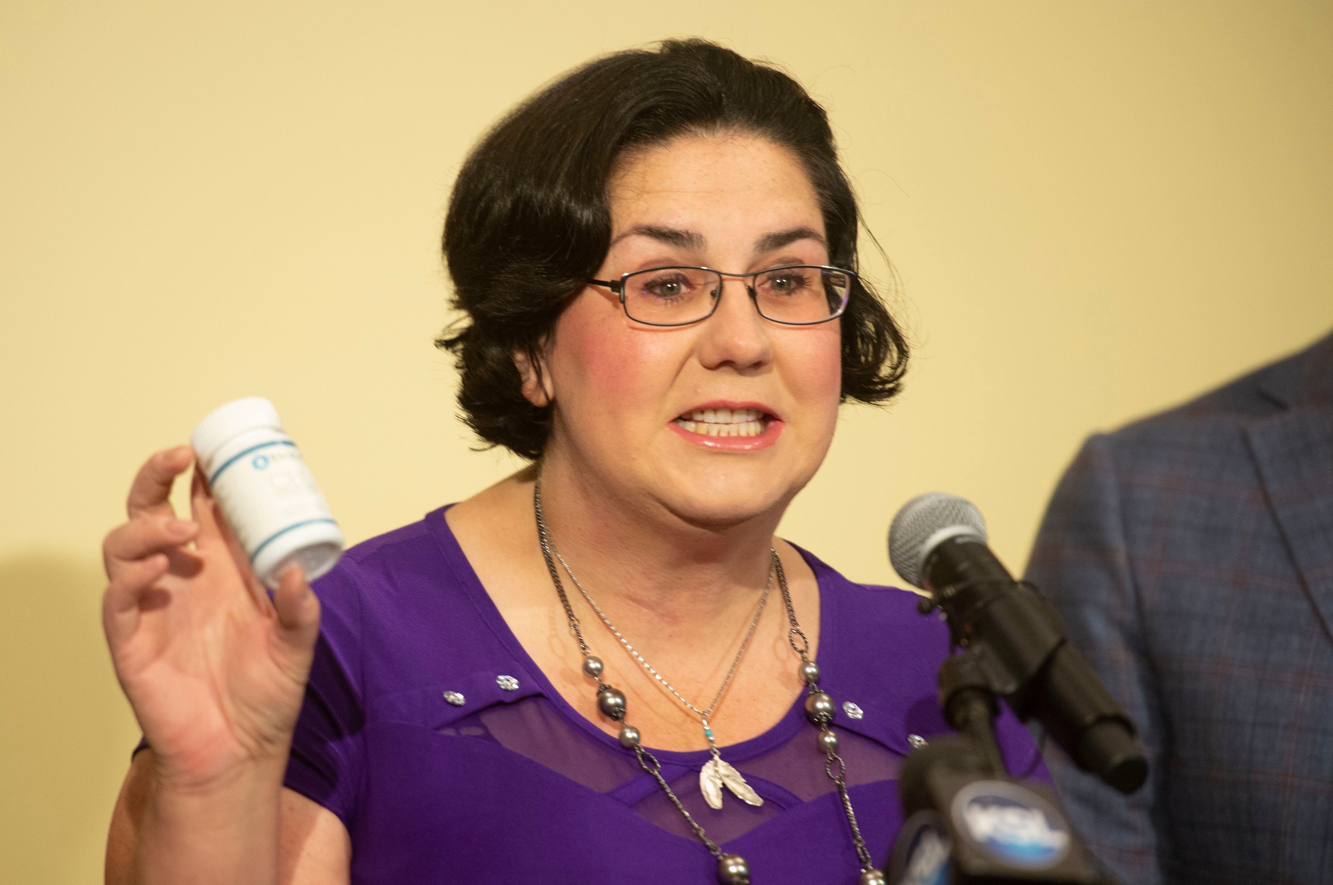 (Rick Egan | The Salt Lake Tribune) Emily Roberts holds a bottle of Endo-C, CBG oil that she takes for her chronic pain, during a news conference. Tuesday, Sept. 10, 2019. Roberts has been threatened with losing her children after testing positive for THC. 