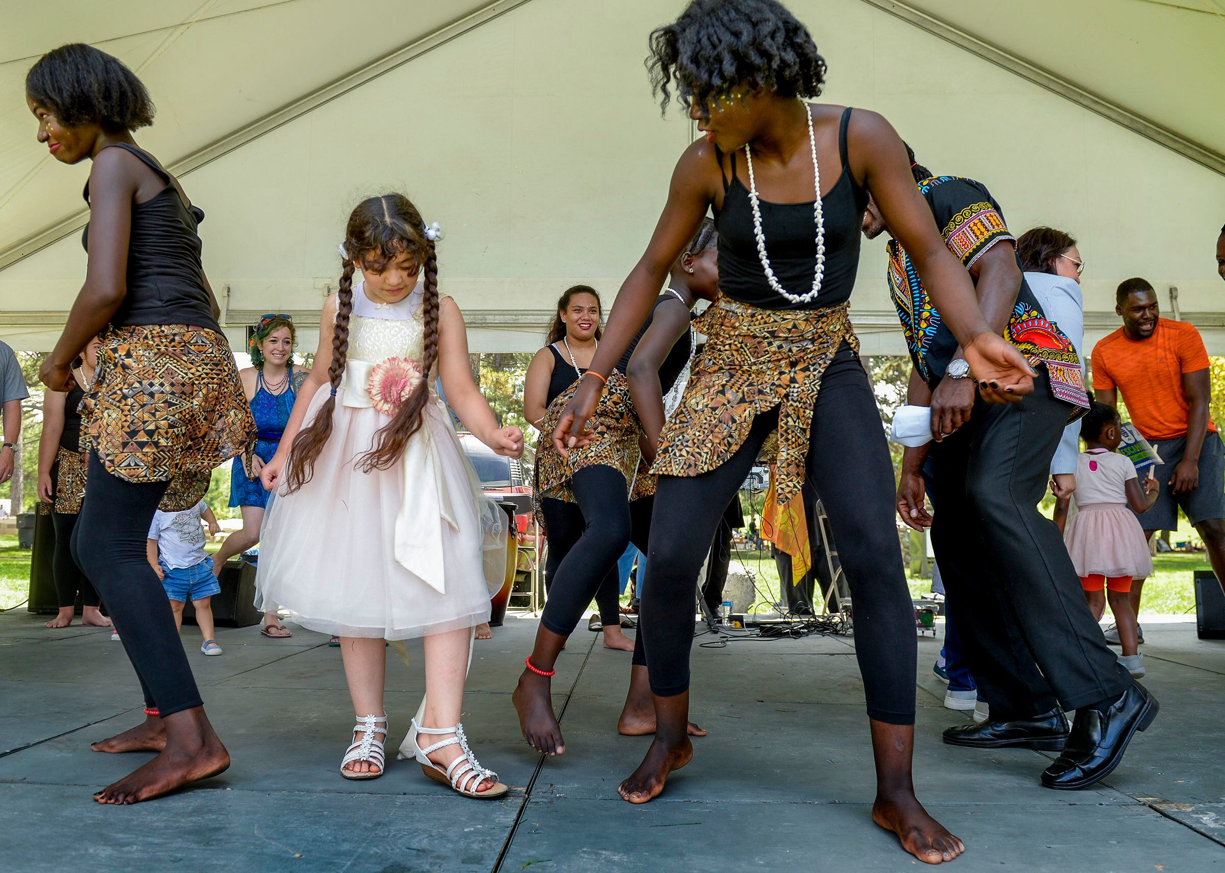 (Leah Hogsten | The Salt Lake Tribune) Fatimah Ali learns African dancing from Ornella Ddjoh during the 4th Annual African Festival sponsored by the United Africans of Utah, Saturday, July 27, 2019 at Liberty Park. The African Festival promotes African tradition, culture and heritage through the arts, food fashion, music and dance.