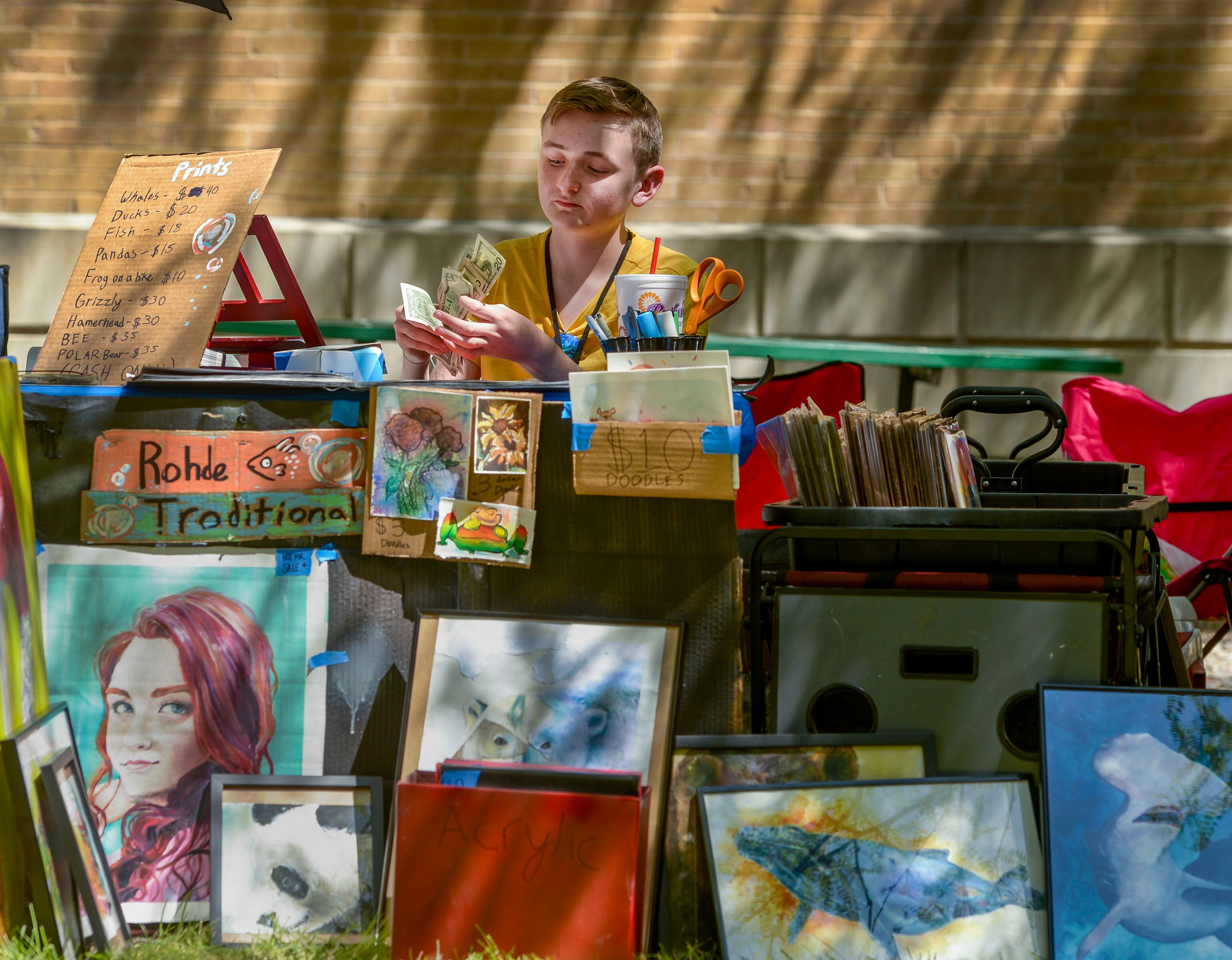 (Leah Hogsten | The Salt Lake Tribune) Mixed media artist Lucas Rohde, 14, counts his proceeds from his art sales at the Craft Lake City DIY Festival Kid Row, where children 14 and under make and sell their products. Craft Lake CityÕs DIY Festival is UtahÕs largest local, three day arts festival with over 300 artisans, DIY engineers, vintage vendors and craft food creators.