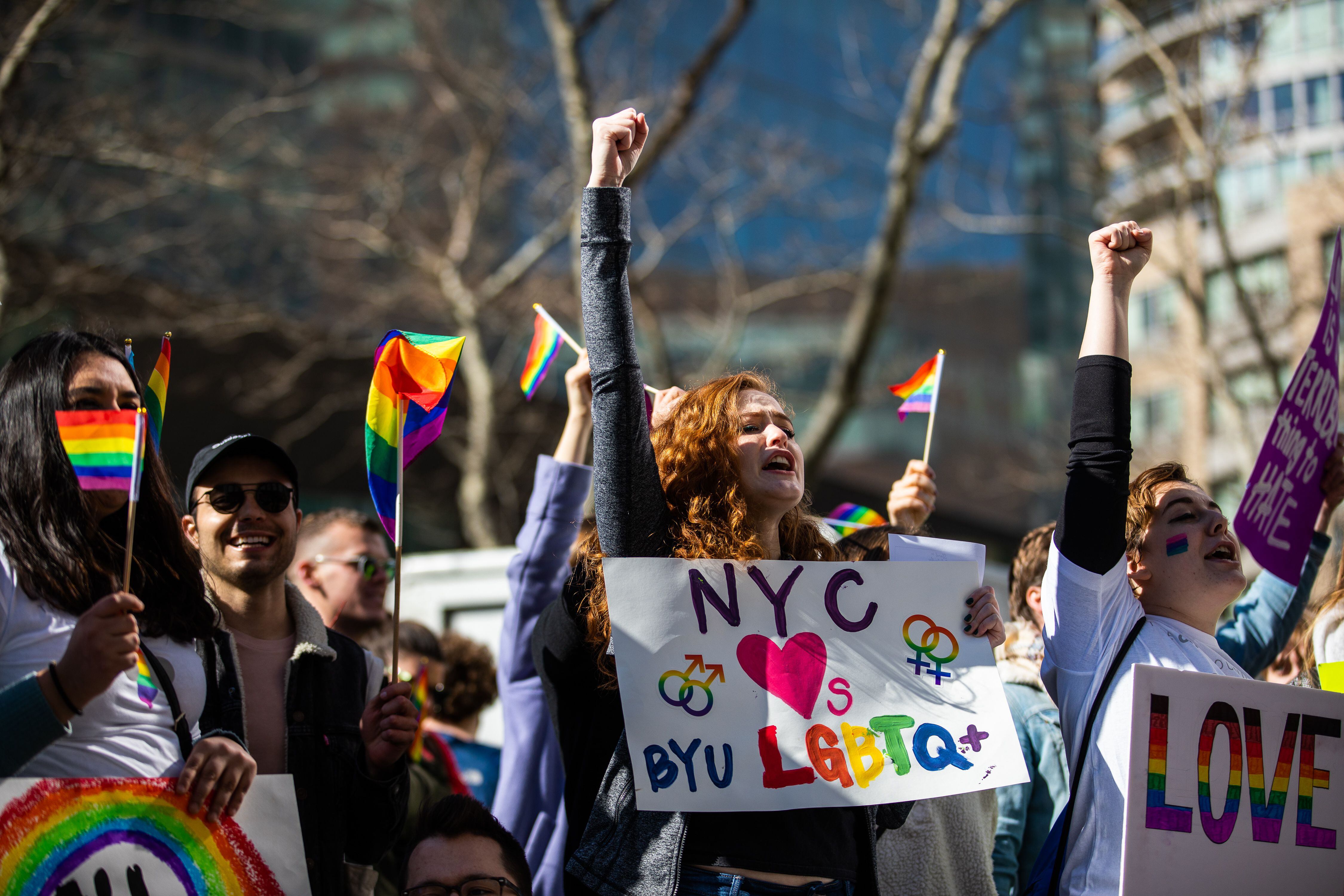 (Demetrius Freeman | for The Salt Lake Tribune) Maddie Hall, 25, center, chants with current and former members of The Church of Jesus Christ of Latter-day Saints, the LGBTQ+ community, and supporters protest at Lincoln Square across from the Latter-day Saints temple in Manhattan on Saturday, March 7, 2020. BYU reinstated policies in its student handbook that prohibit "homosexual behavior."