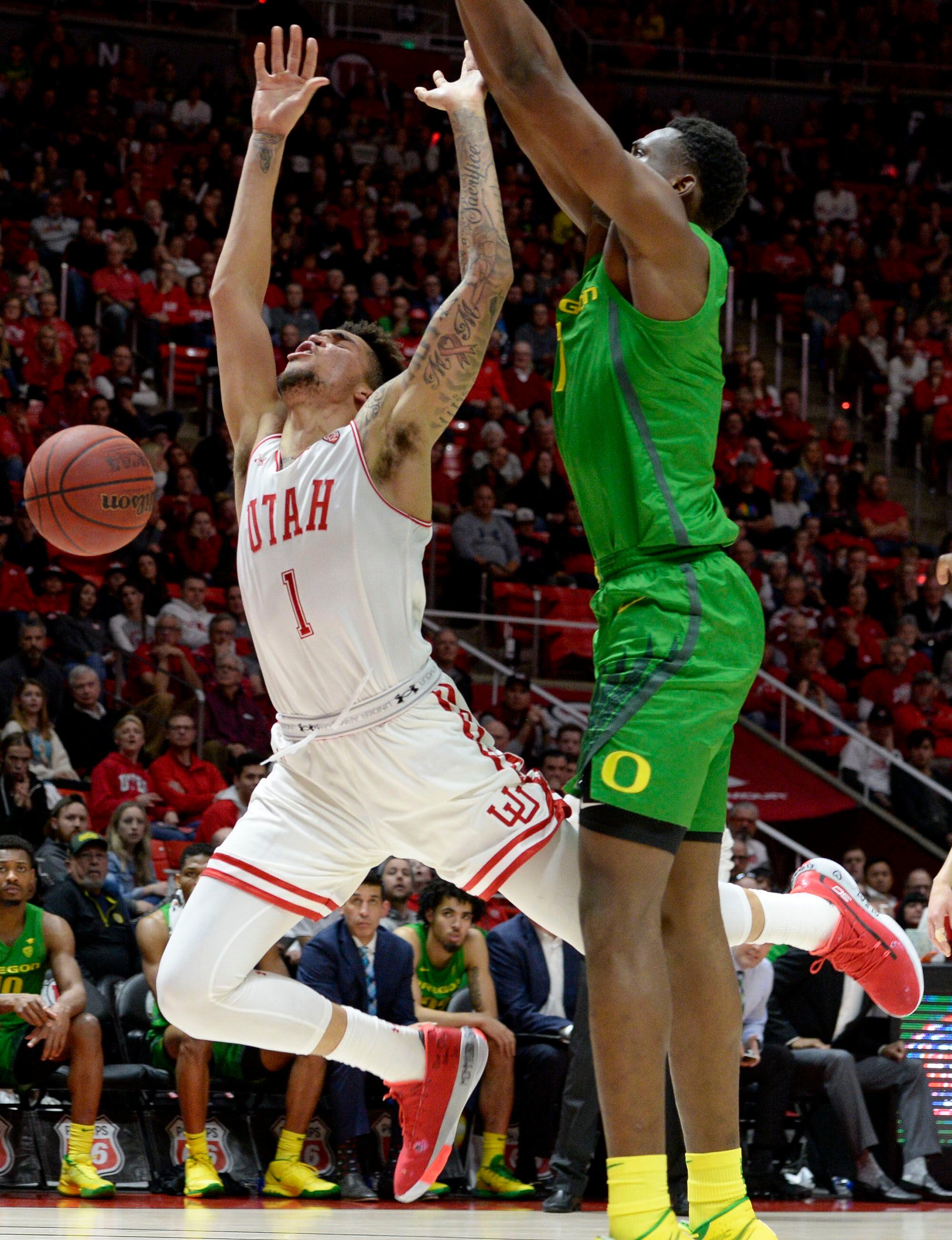 (Leah Hogsten | The Salt Lake Tribune) Utah Utes forward Timmy Allen (1) is fouled by Oregon Ducks center N'Faly Dante (1) as the University of Utah basketball team hosts No. 4 Oregon, Jan. 4, 2020, at the Huntsman Center.