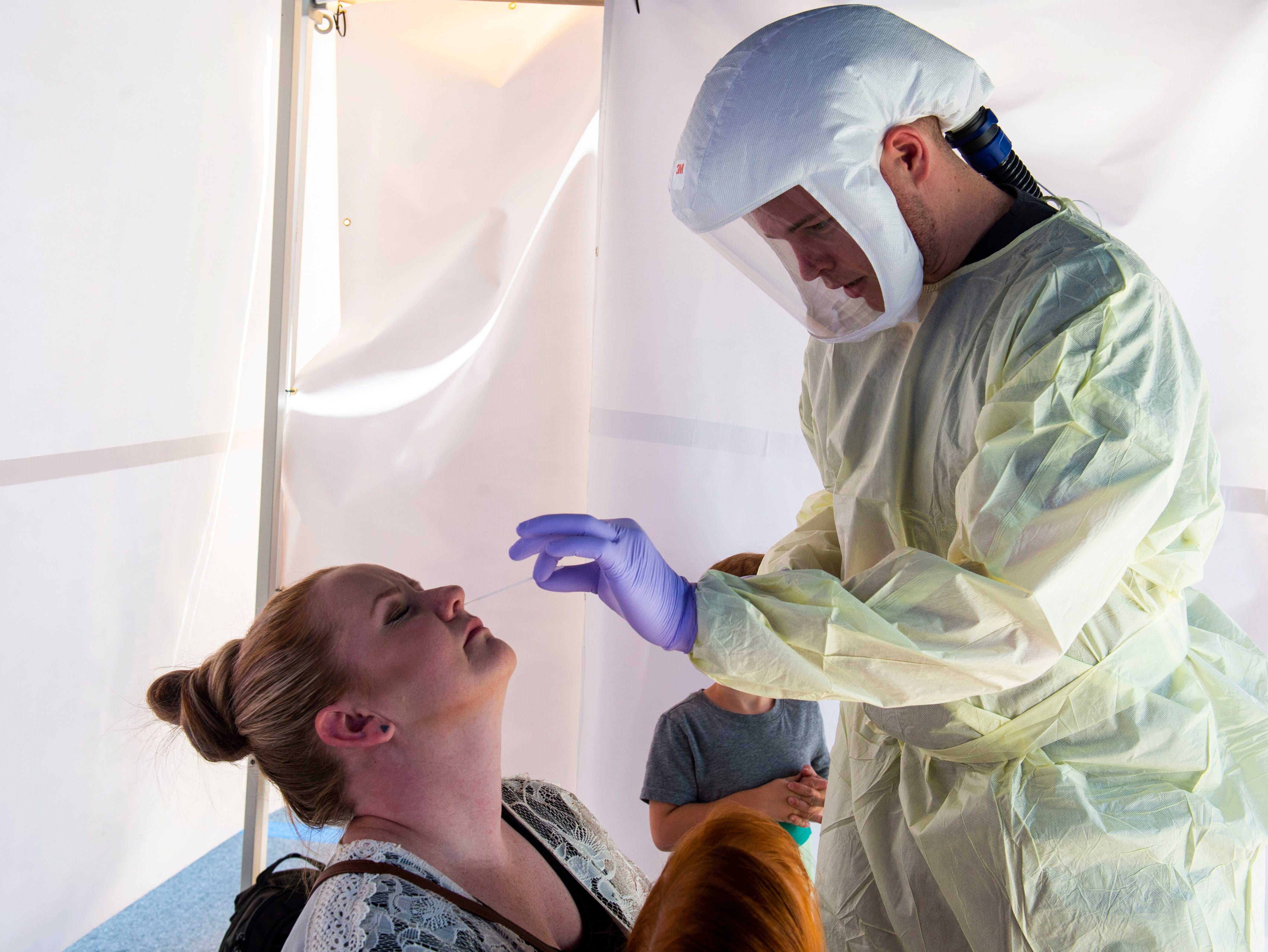 (Rick Egan | The Salt Lake Tribune) Cassie Neeley gets tested by Intermountain Healthcare medical assistant, Connor Meads, at the Intermountain Healthcare Coronavirus Mobile Testing Unit at Utah Valley Hospital in Provo, Friday May 8, 2020.