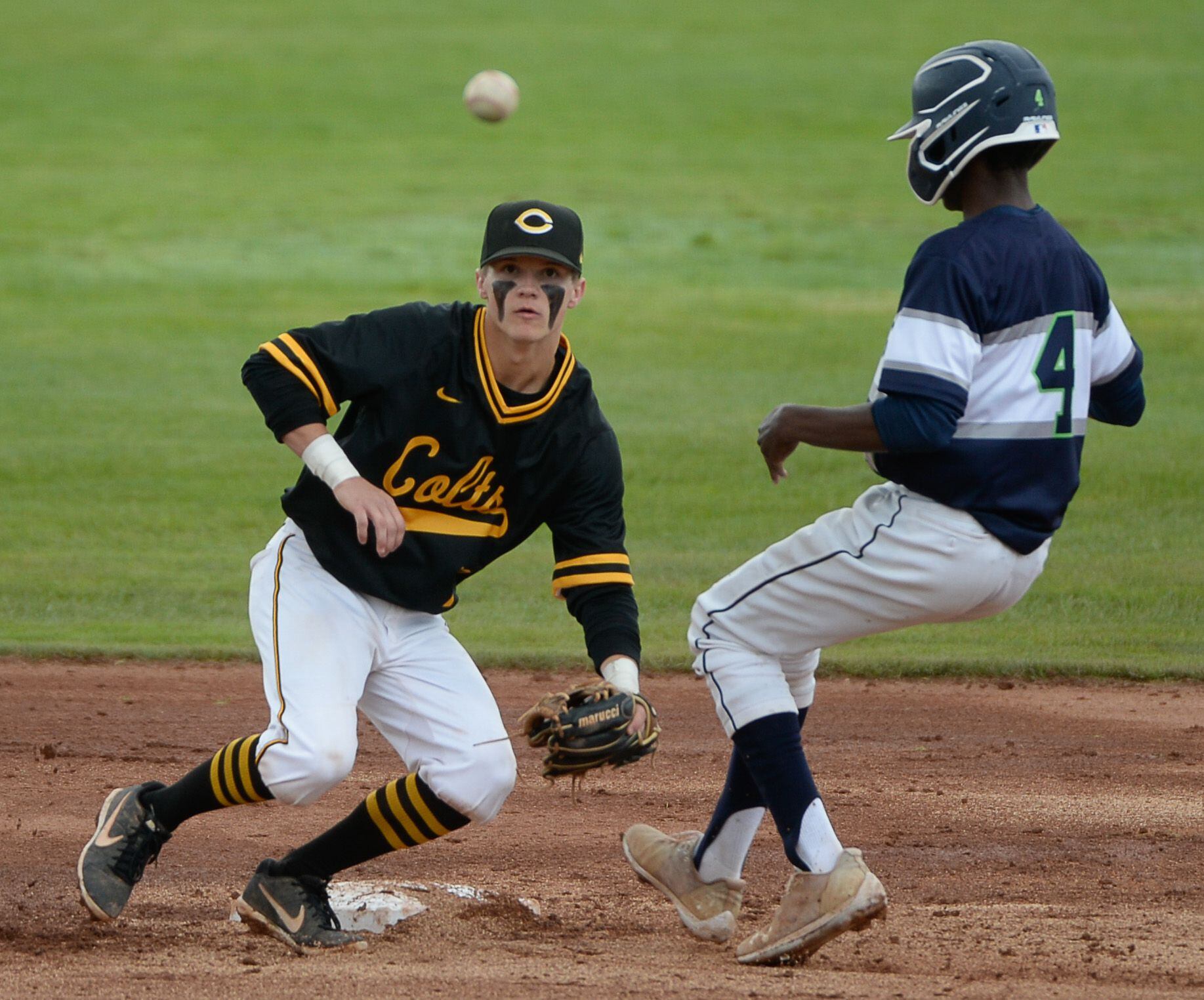 (Francisco Kjolseth | The Salt Lake Tribune) Cade Perkins of Cottonwood keeps his eye on the ball as Will Thomas of Timpanogos slips safely in to second base during the 5A baseball championship game at UCCU Stadium on the UVU campus in Orem, Friday, May 24, 2019.