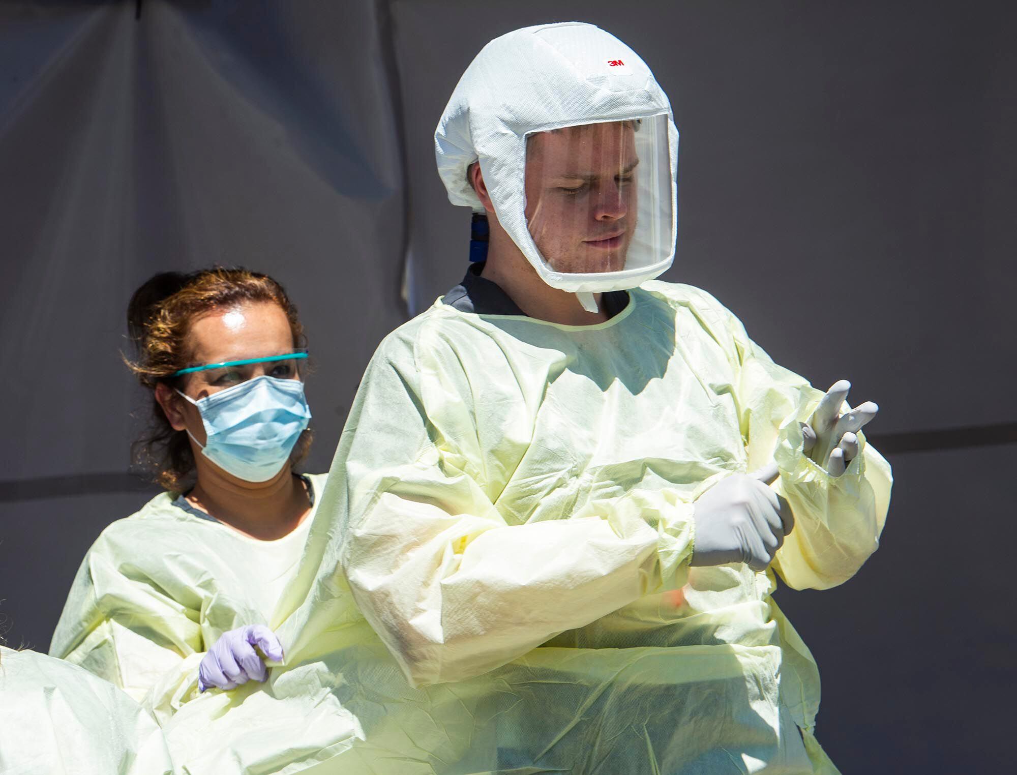 (Rick Egan | The Salt Lake Tribune) Medical assists prepare for the next patient, at the Intermountain Healthcare Coronavirus Mobile Testing Unit at Utah Valley Hospital in Provo, Friday May 8, 2020.