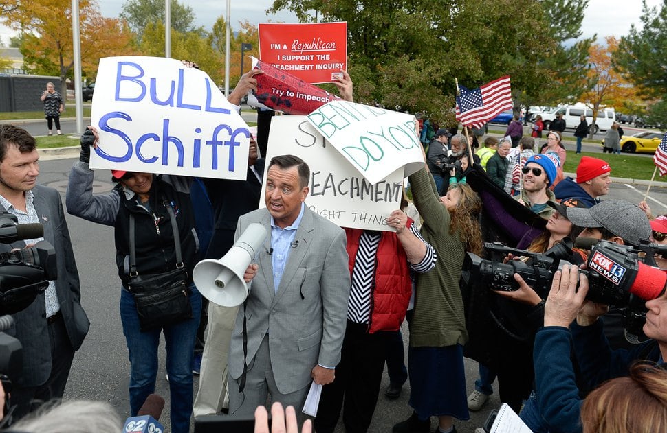 (Francisco Kjolseth | Tribune file photo) Former Utah House Speaker Greg Hughes uses a bullhorn to rally supporters of President Donald Trump as two competing demonstations spar near U.S. Rep. Ben McAdams' office in West Jordan. One group was there to support Utah's only Democrat in Congress and one to criticize him for supporting the impeachment inquiry of Trump, Oct. 9, 2019.