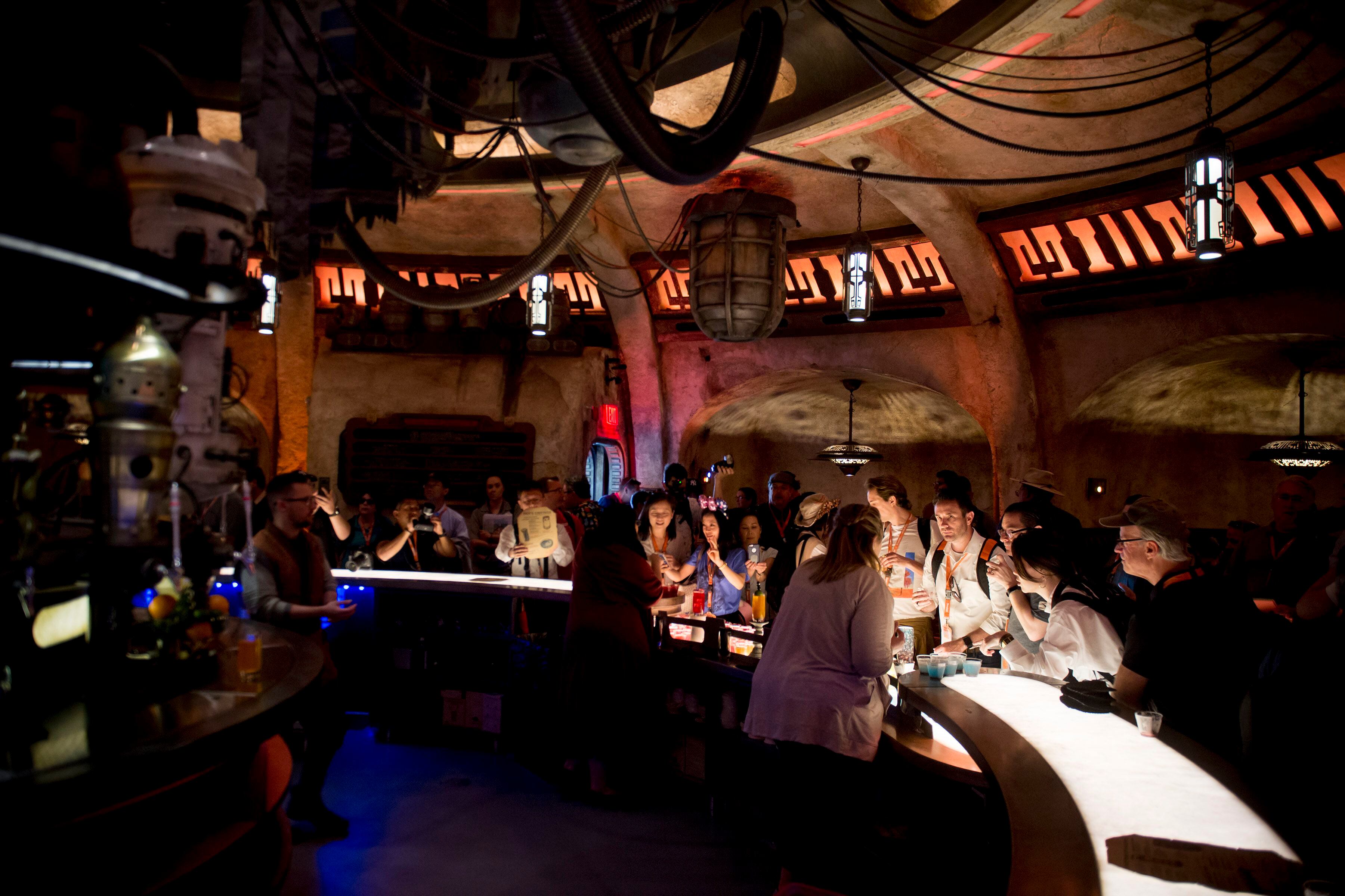 (Jeremy Harmon | The Salt Lake Tribune) Patrons sample drinks at Oga's Cantina at Star Wars: Galaxy's Edge in Anaheim, Ca. on Wednesday, May 29, 2019. The cantina is reminiscent of the one in the original Star Wars film from 1977.