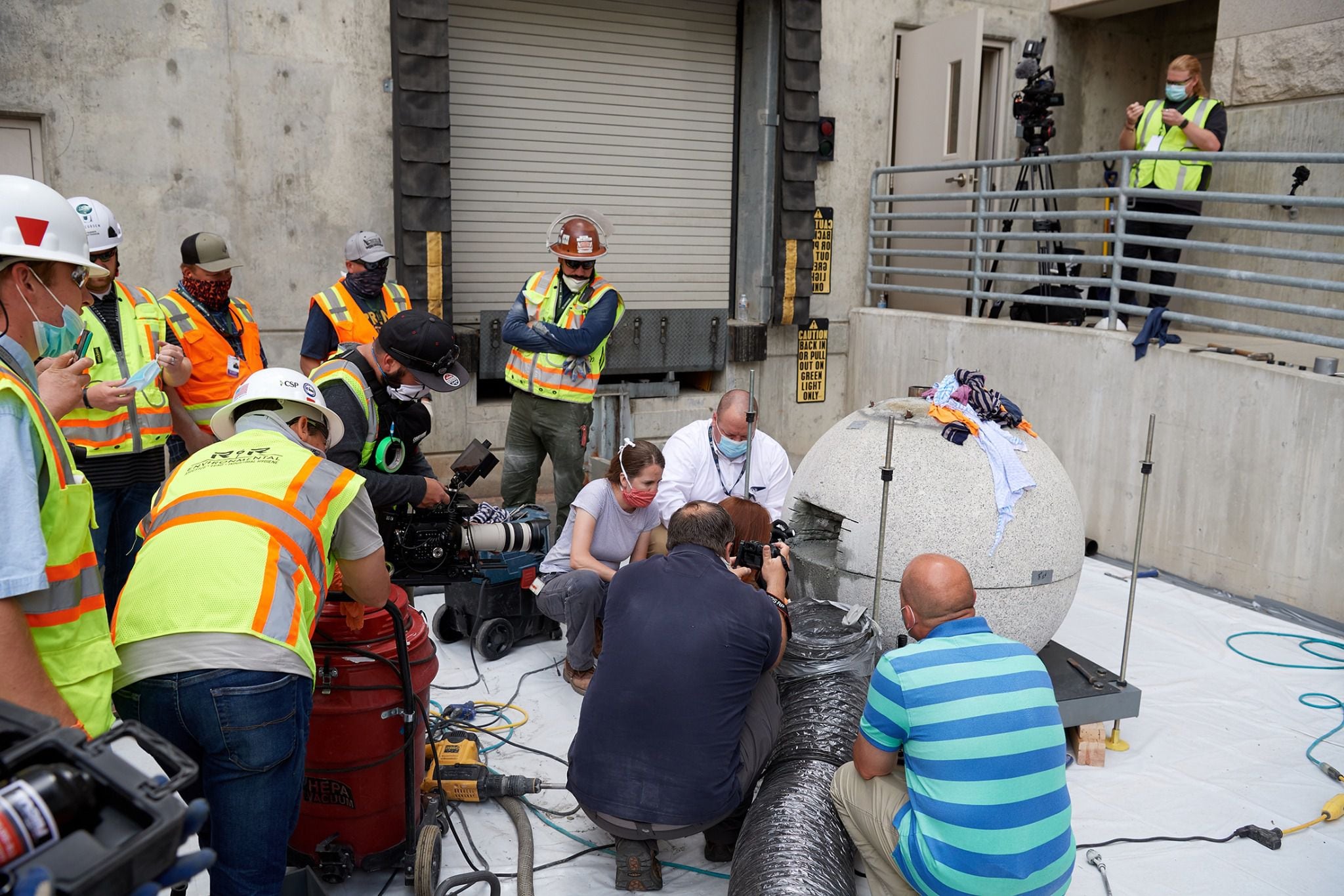 (photo courtesy The Church of Jesus Christ of Latter-day Saints) Preservation specialists begin the process of cutting into and retrieving items from the time capsule within the capstone of the Salt Lake Temple on May 18, 2020, at the Church History Library.