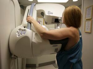 FILE - In this May 22, 2015 photo, a woman gets a mammogram at the University of Michigan Cancer Center in Ann Arbor, Mich.  (Kimberly P. Mitchell/Detroit Free Press via AP, File)