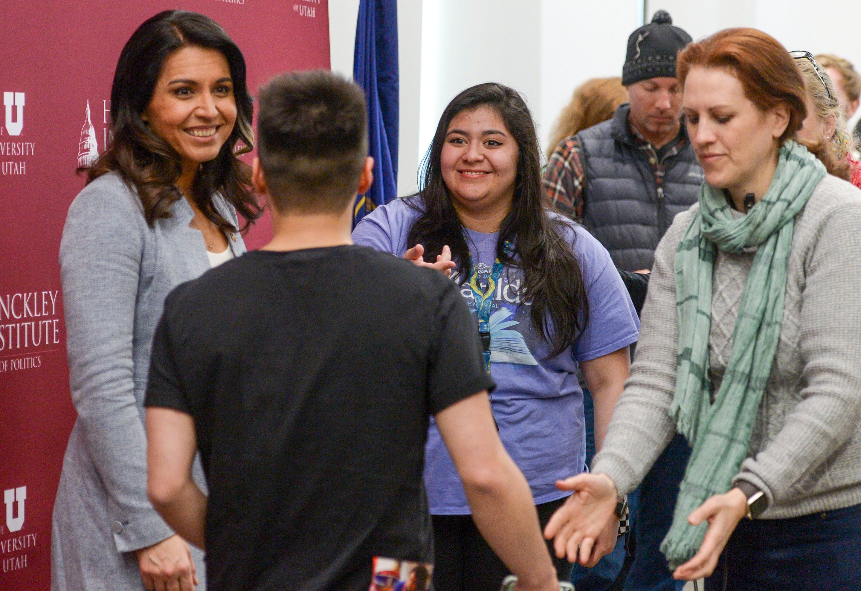 (Leah Hogsten | The Salt Lake Tribune) l-r Tulsi Gabbard shares a laugh with Brexton Olesky-Lee and his girlfriend Mariana Villarreal during a meet and greet. Gabbard, U.S. Representative for Hawaii' and Democratic presidential candidate, delivers her stump speech at a "meet the candidate" event at the University of Utah's Hinckley Institute of Politics, Feb. 21, 2020.