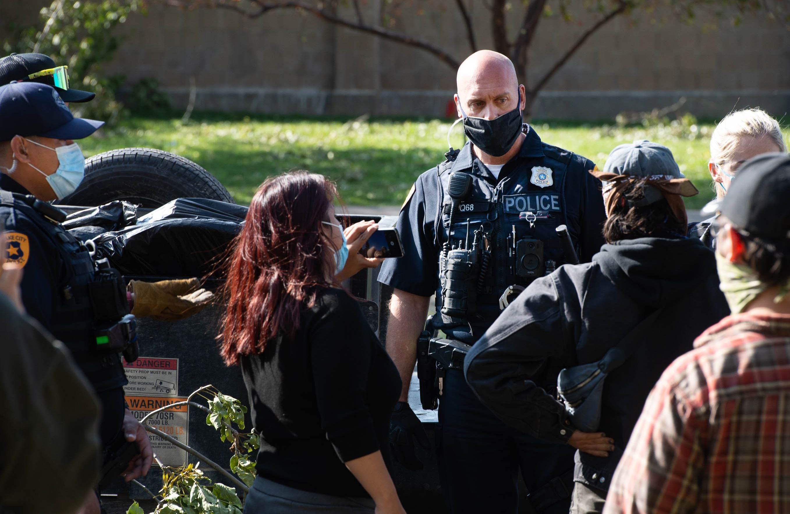 (Francisco Kjolseth | The Salt Lake Tribune) Police are confronted by homeless advocates as the Salt Lake County Health Department forces a clean up of homeless camps set up near Taufer Park in Salt Lake City on Thursday, Sept. 10, 2020.