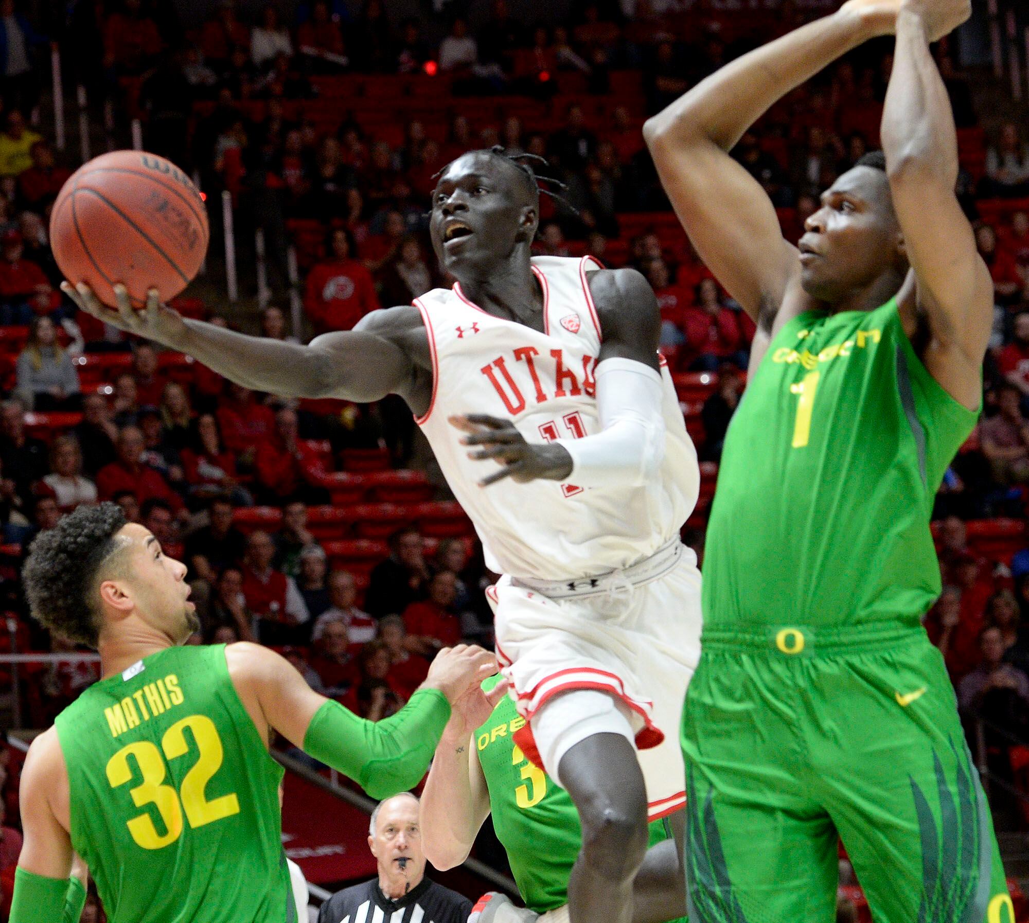 (Leah Hogsten | The Salt Lake Tribune) Utah Utes guard Both Gach (11) drives the court past the Ducks defense as the University of Utah basketball team hosts No. 4 Oregon, Jan. 4, 2020, at the Huntsman Center.