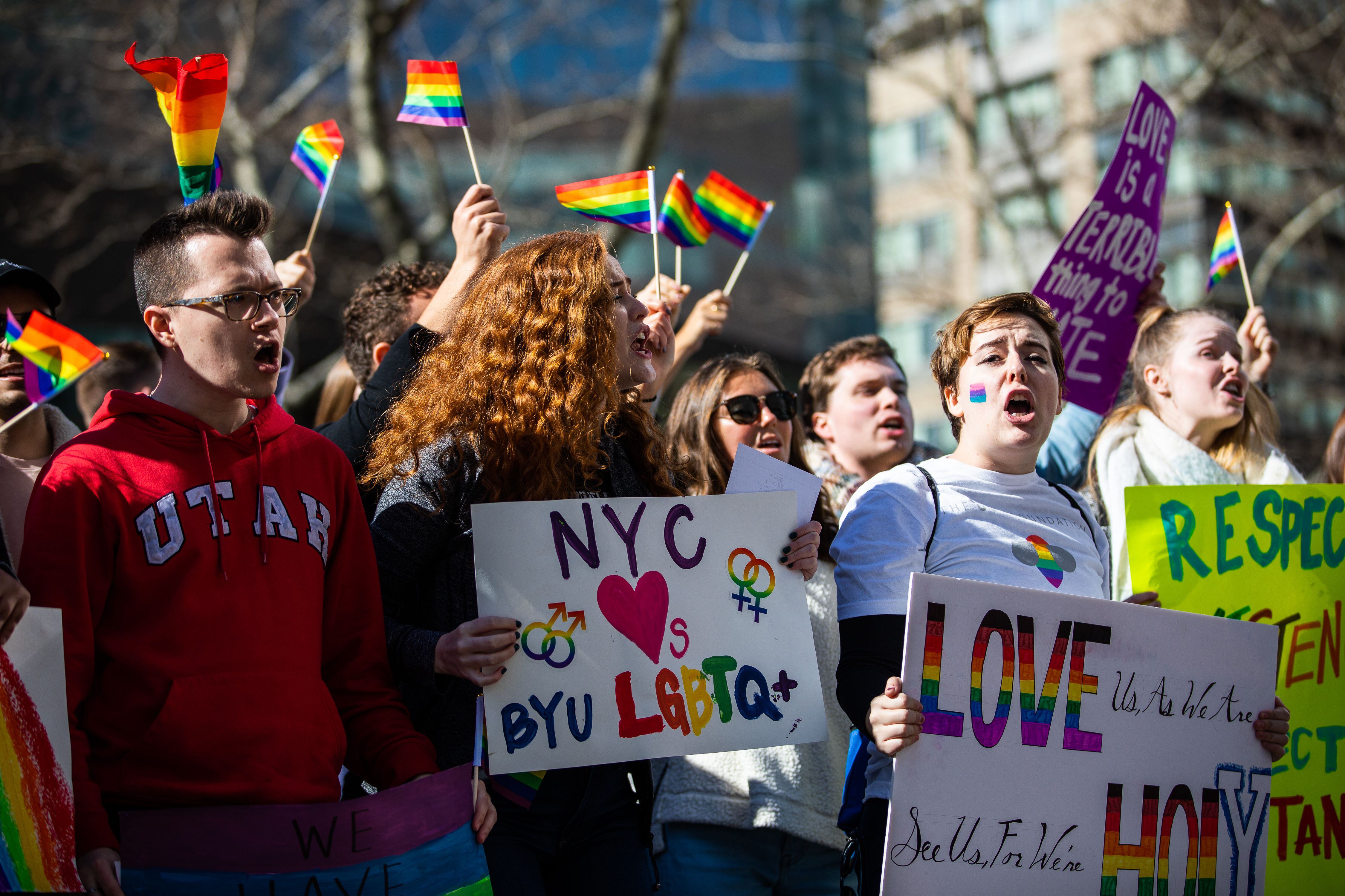 (Demetrius Freeman | for The Salt Lake Tribune) Maddie Hall, 25, center, chants with current and former members of The Church of Jesus Christ of Latter-day Saints, the LGBTQ+ community, and supporters demonstrate at Lincoln Square across from the Latter-day Saints temple in Manhattan on Saturday, March 7, 2020. BYU reinstated policies in its student handbook that prohibit "homosexual behavior."