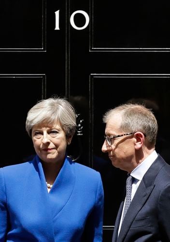 British Prime Minister Theresa May and her husband Philip stand on the  doorstep of 10 Downing street, London, after addressing the press Friday,  June 9, 2017 following an audience with Britain's Queen