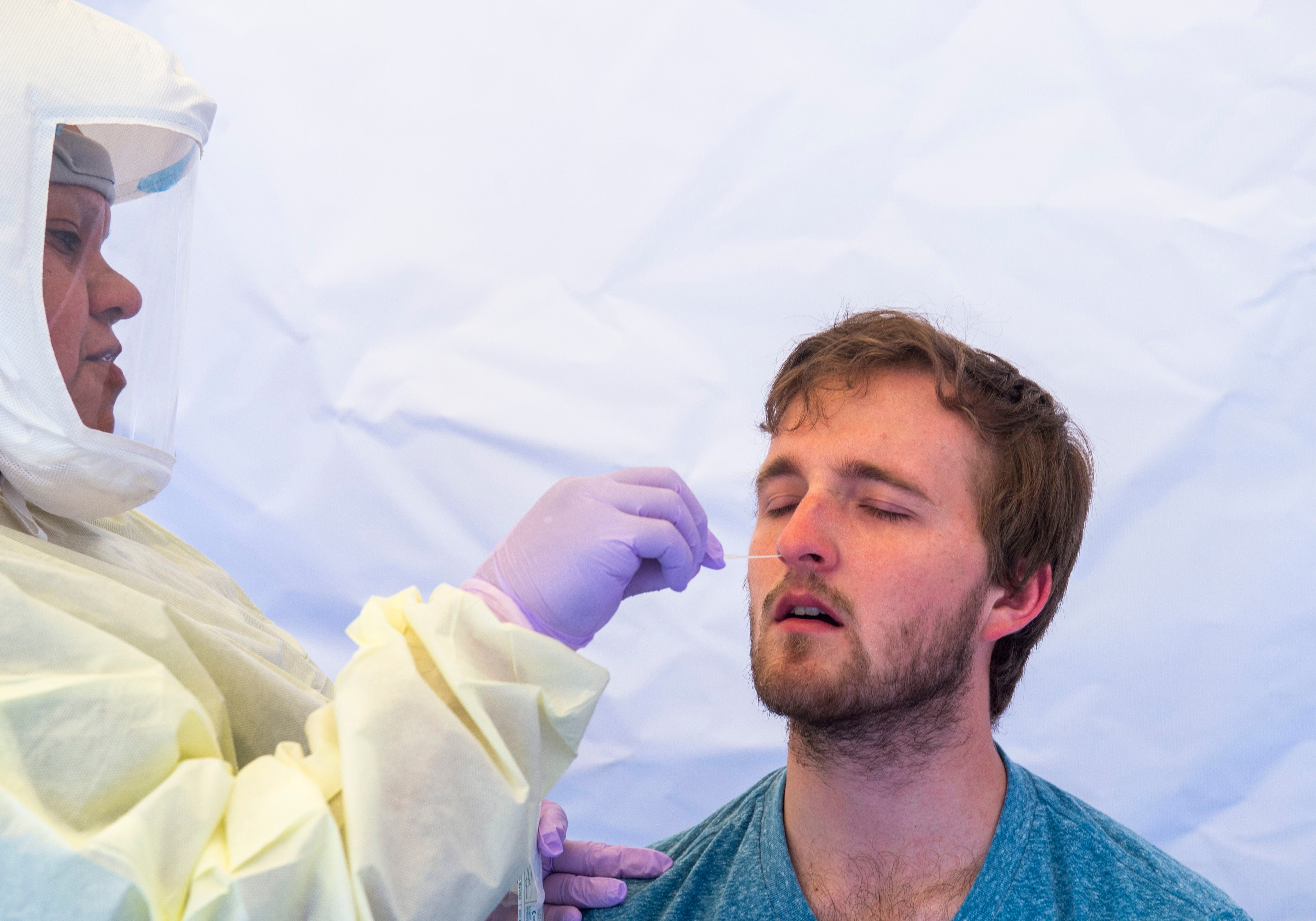 (Rick Egan | The Salt Lake Tribune) Intermountain Healthcare medical assistant, Latoya Dovila, tests Preston Jenson, at the Intermountain Healthcare Coronavirus Mobile Testing Unit at Utah Valley Hospital in Provo, Friday May 8, 2020.