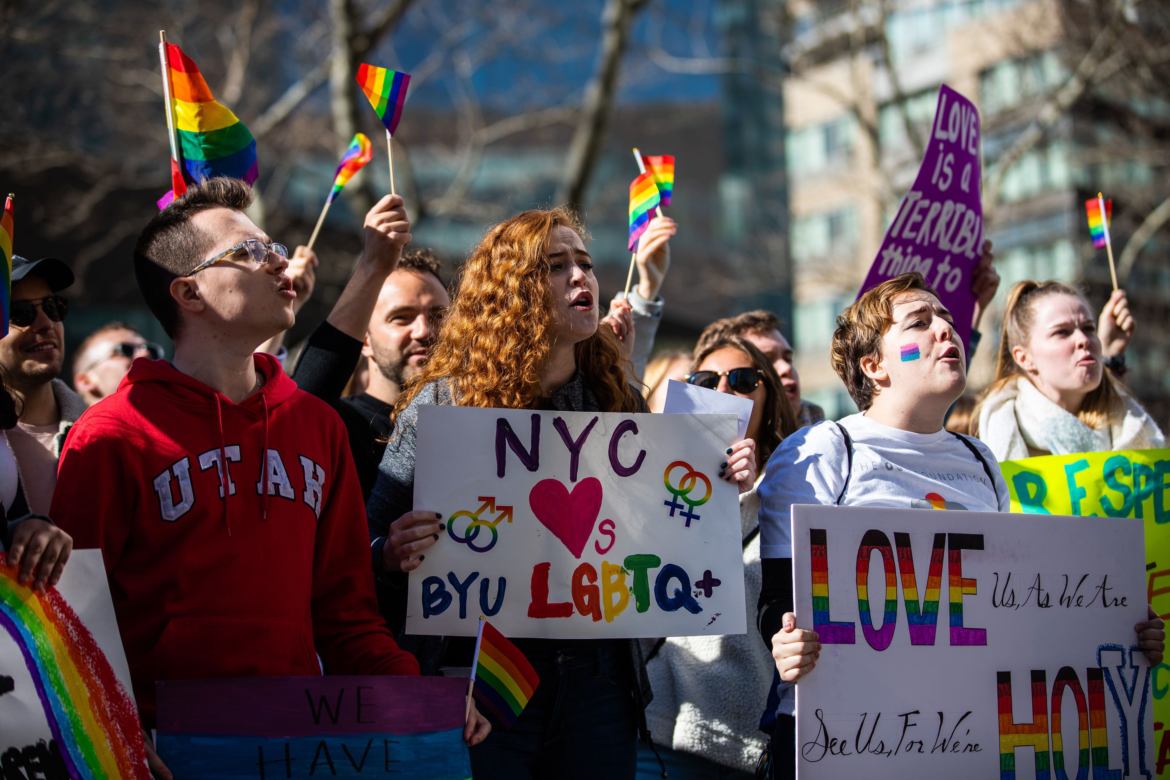 (Demetrius Freeman | for The Salt Lake Tribune) Maddie Hall, 25, center, chants with current and former members of The Church of Jesus Christ of Latter-day Saints, the LGBTQ+ community, and supporters at Lincoln Square across from the Latter-day Saints temple in Manhattan on Saturday, March 7, 2020. BYU reinstated policies in its student handbook that prohibit "homosexual behavior."