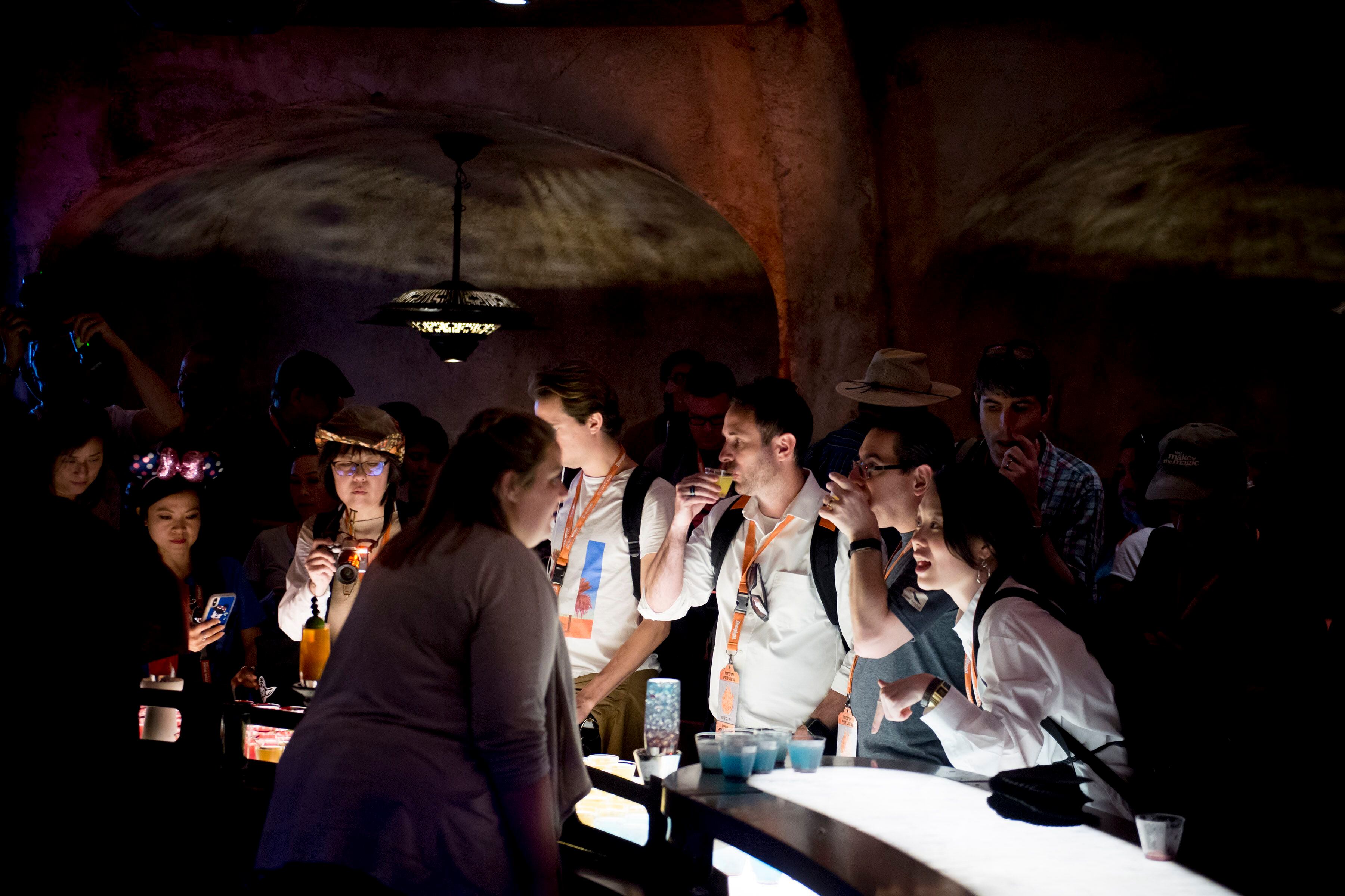 (Jeremy Harmon | The Salt Lake Tribune) Patrons sample drinks at Oga's Cantina at Star Wars: Galaxy's Edge in Anaheim, Ca. on Wednesday, May 29, 2019. The cantina is reminiscent of the one in the original Star Wars film from 1977.