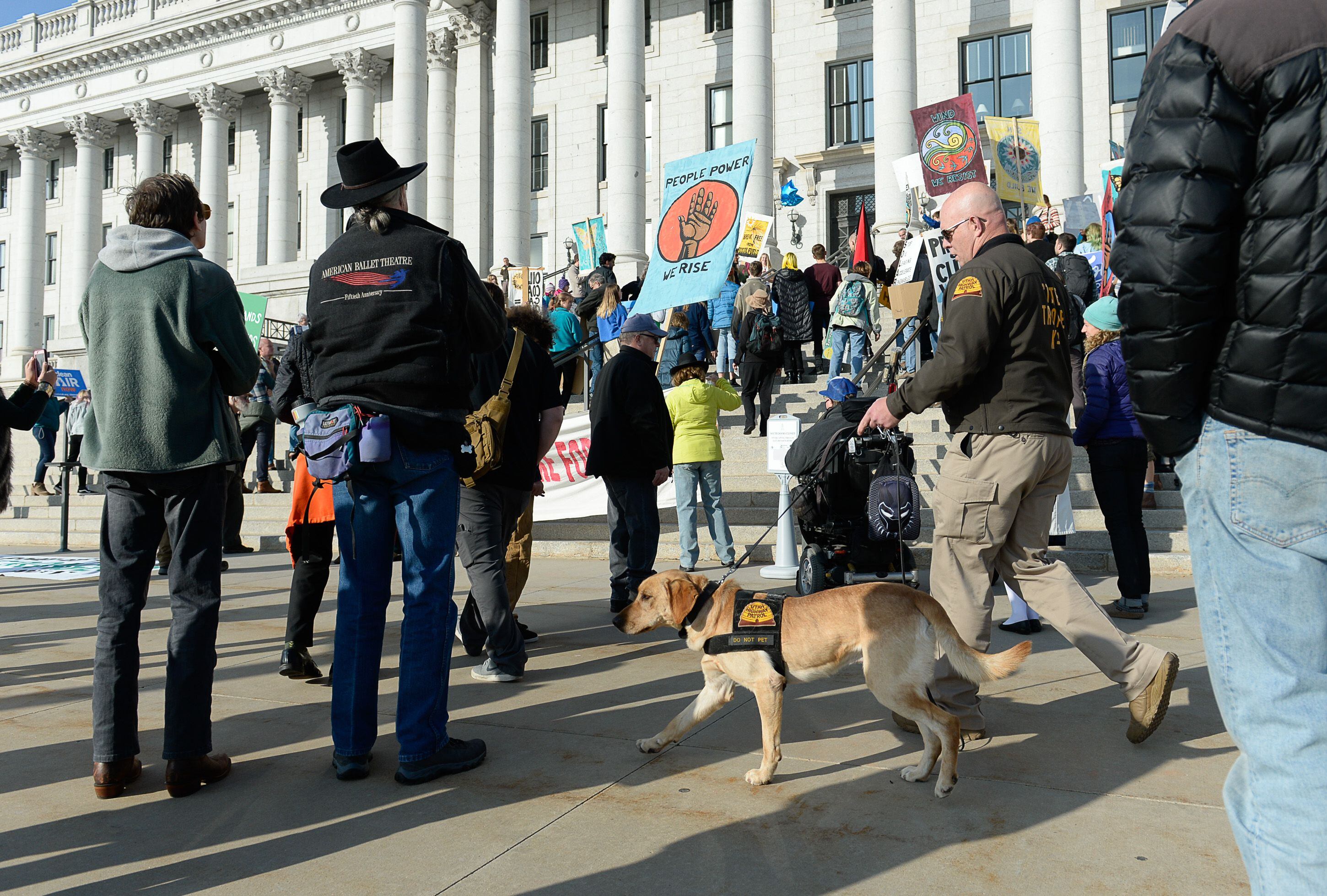 (Francisco Kjolseth | The Salt Lake Tribune) A highway patrol K-9 bomb sniffing dog is walked throughout the crowd on the steps of the Utah Capitol on Friday, Dec. 6, 2019, as Fridays For Future, Utah Youth Environmental Solutions, and others gather to rally for clean air and fight for comprehensive climate change solutions. The strike was also in opposition to UtahÕs final oil and gas lease sale of 2019 that will auction off public lands and further fossil fuel development.