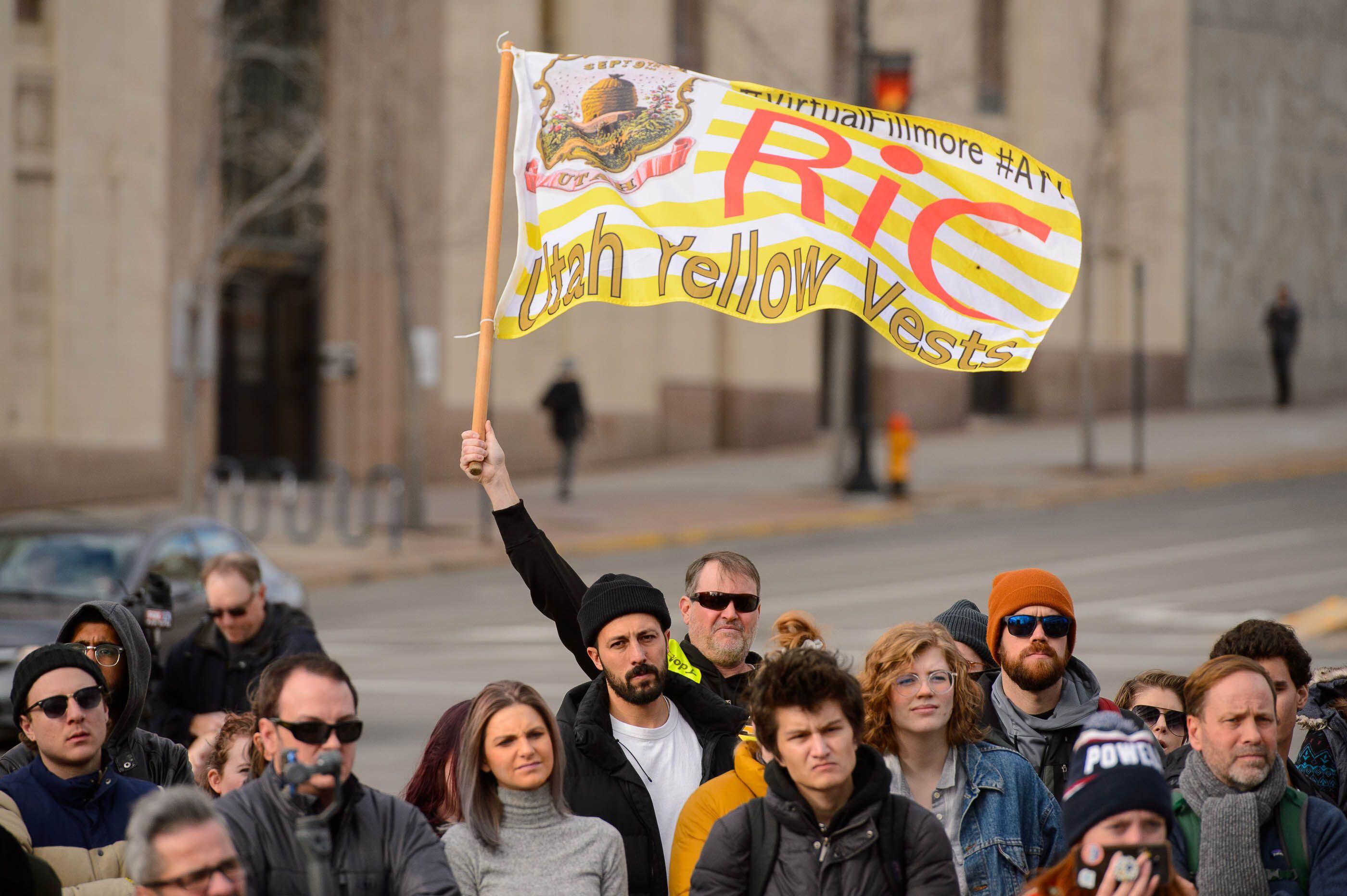 (Trent Nelson | The Salt Lake Tribune) Robert Walton waves a flag as people gather in front of the Federal Building in Salt Lake City on Saturday, Jan. 4, 2020 to protest the escalation of tensions with Iran.