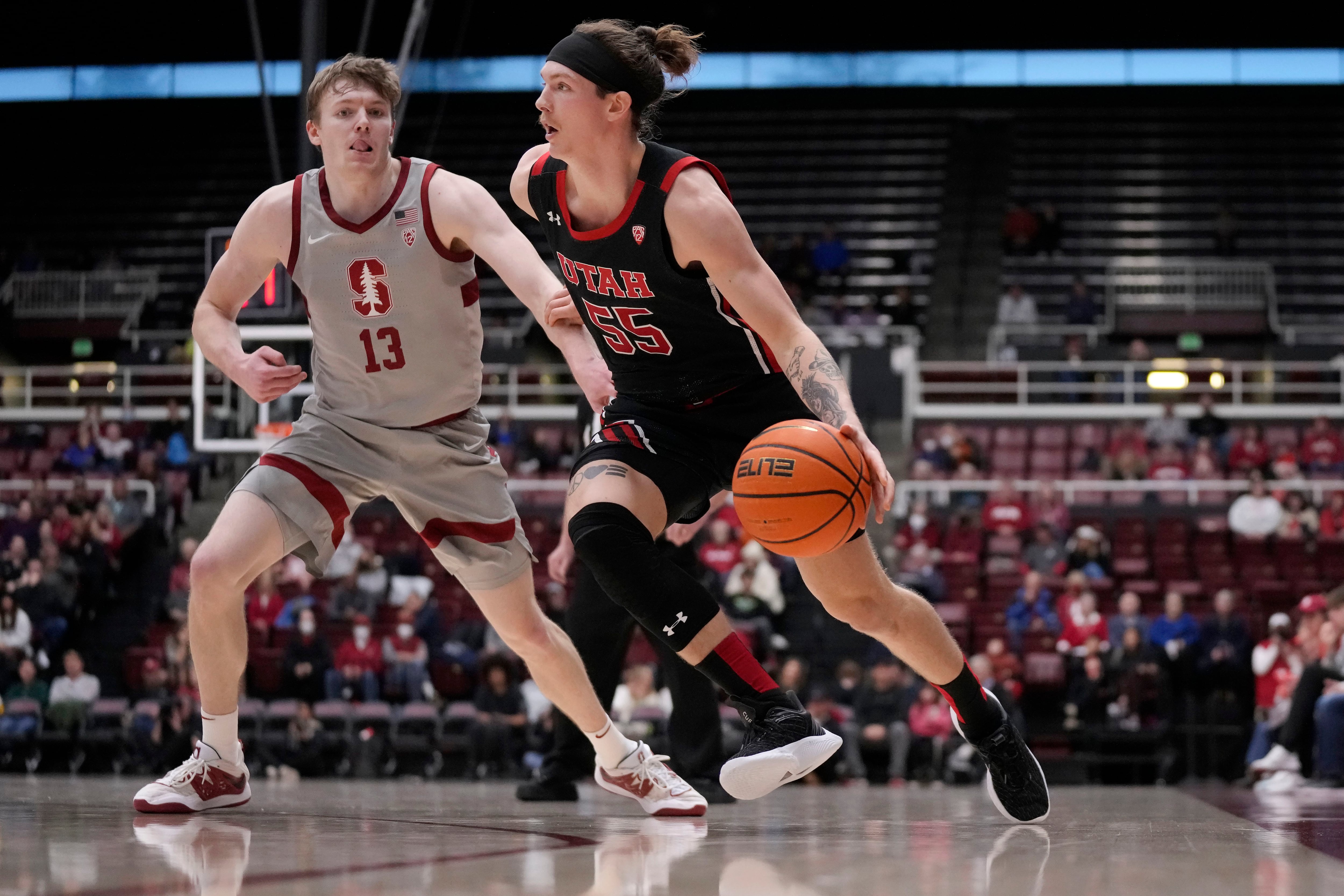 Utah guard Gabe Madsen (55) drives to the basket against Stanford guard Michael Jones (13) during the second half of an NCAA college basketball game in Stanford, Calif., Saturday, Dec. 31, 2022. (AP Photo/Jeff Chiu)